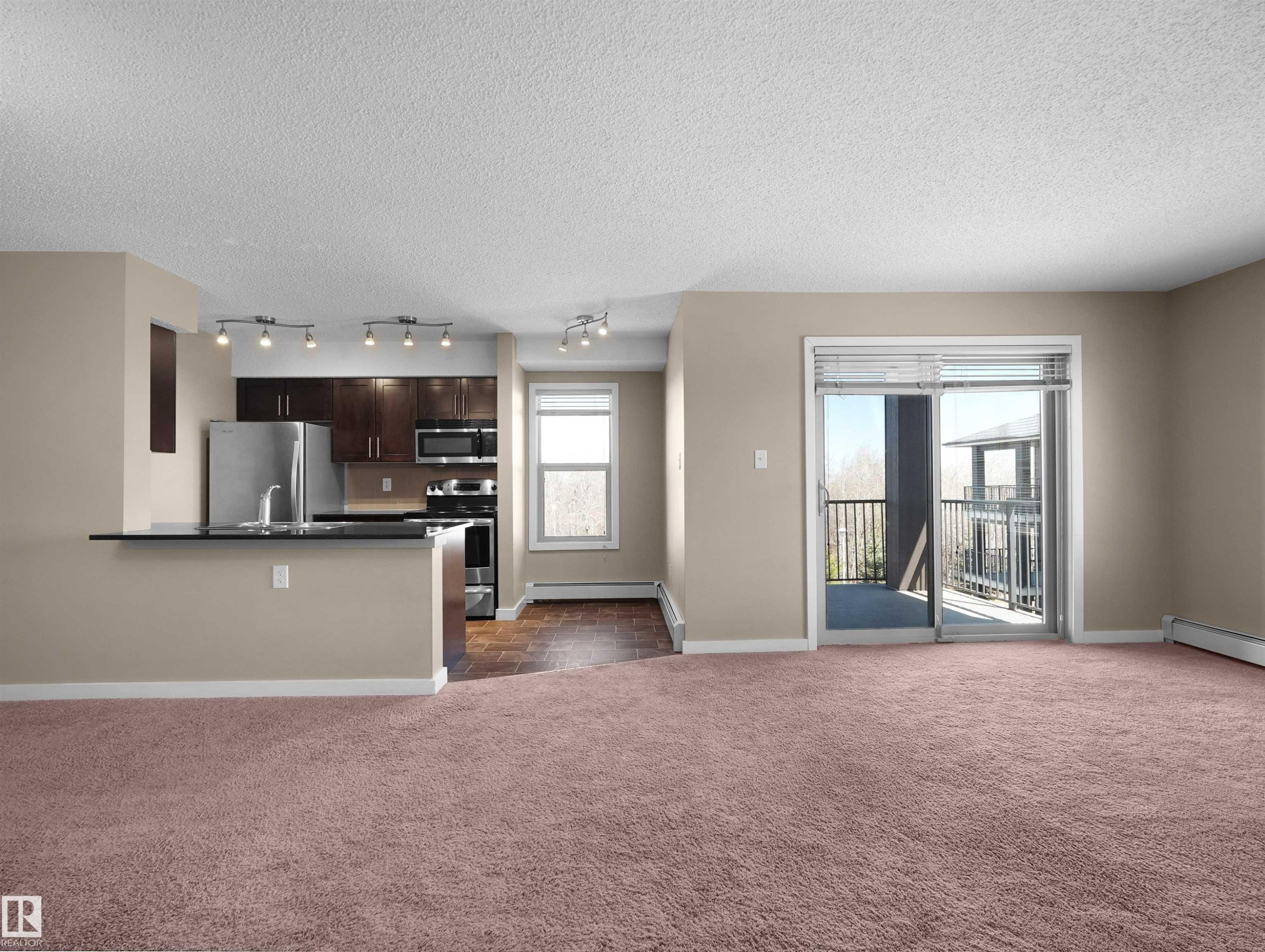 Open-concept living area featuring plush carpet flooring - 417 1060 Mcconachie Boulevard, Edmonton, AB - Indoor Photo Showing Other Room