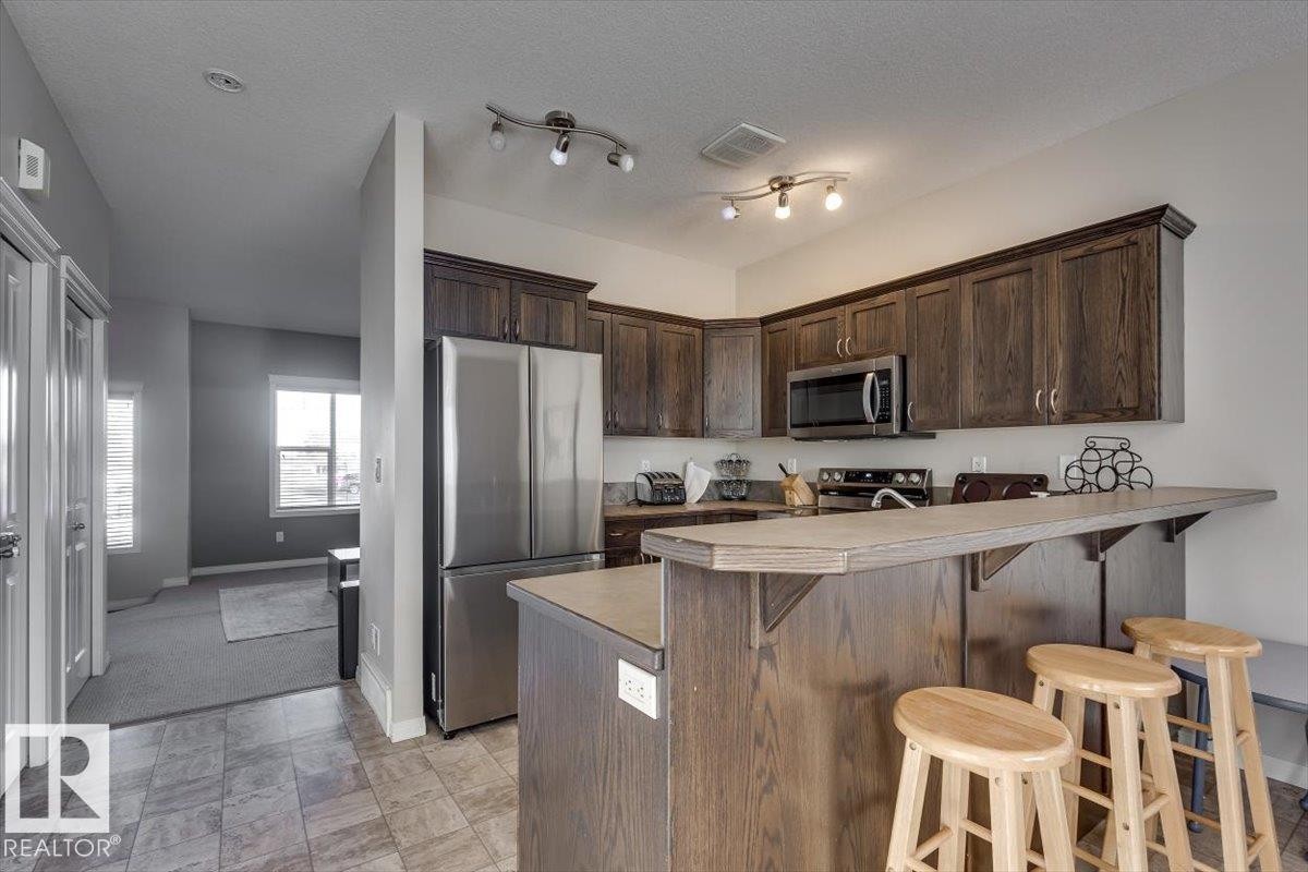 #111 50 Lucky Pl, Sylvan Lake, AB - Indoor Photo Showing Kitchen With Stainless Steel Kitchen
