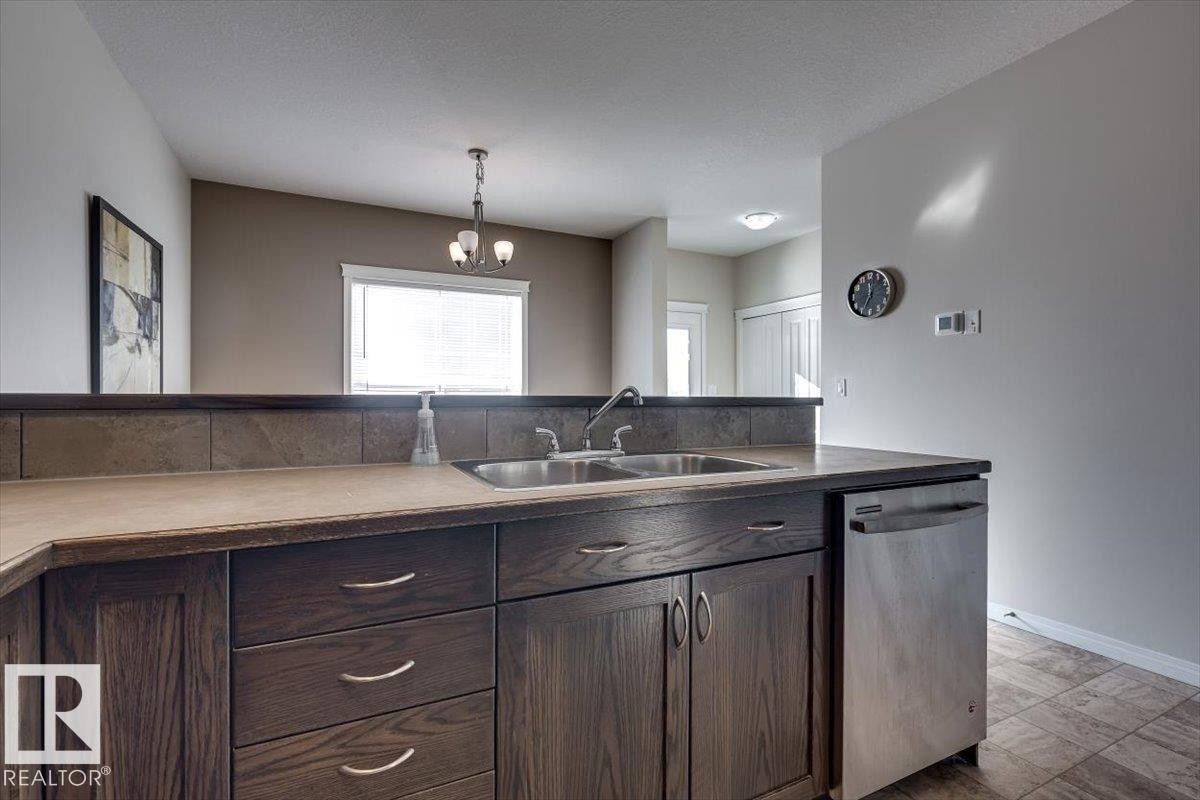 #111 50 Lucky Pl, Sylvan Lake, AB - Indoor Photo Showing Kitchen With Double Sink