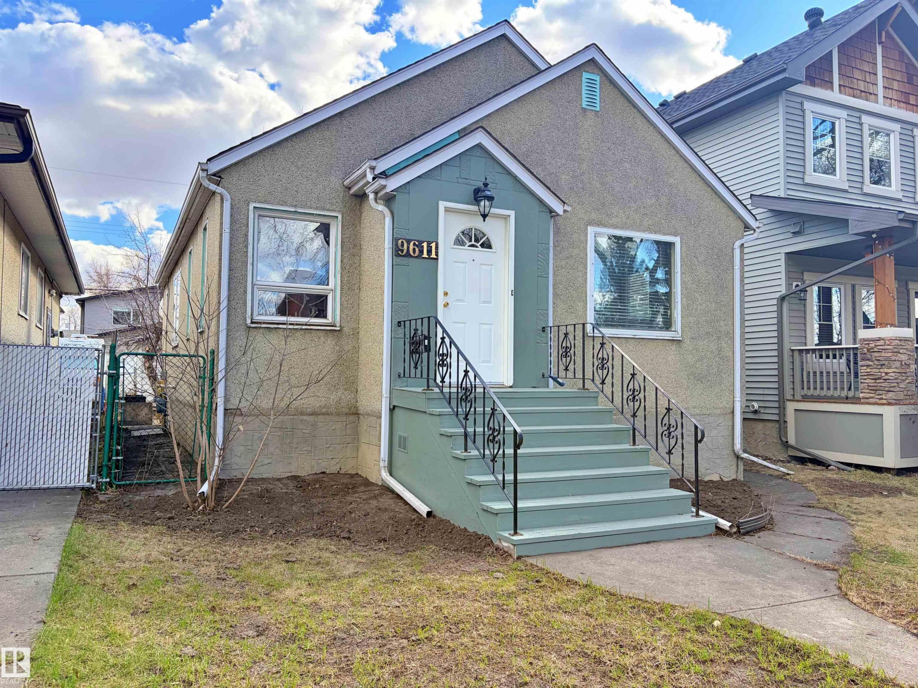 Stucco exterior with a peaked roofline - 9611 81 Avenue, Edmonton, AB - Outdoor
