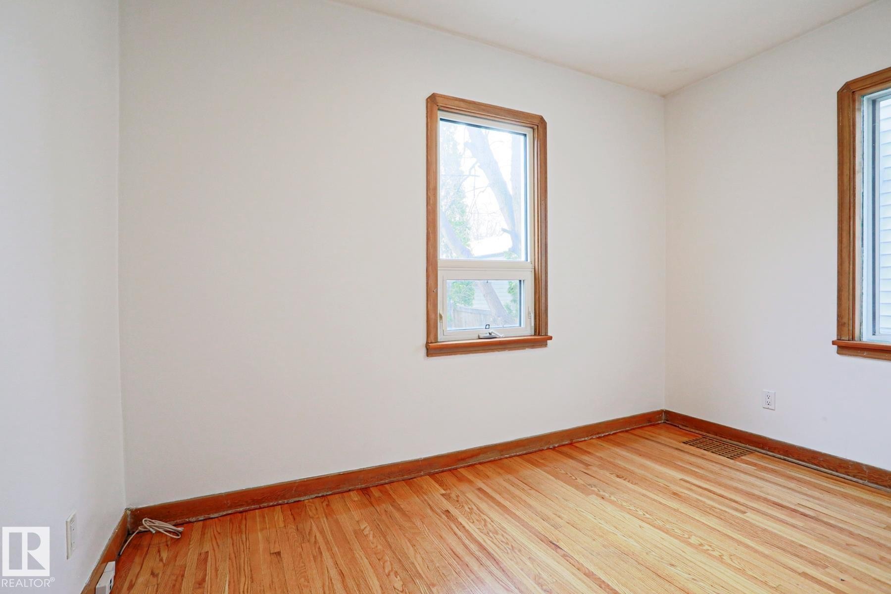 Bright interior space featuring light-colored walls and wood-finish flooring - 9611 81 Avenue, Edmonton, AB - Indoor Photo Showing Other Room
