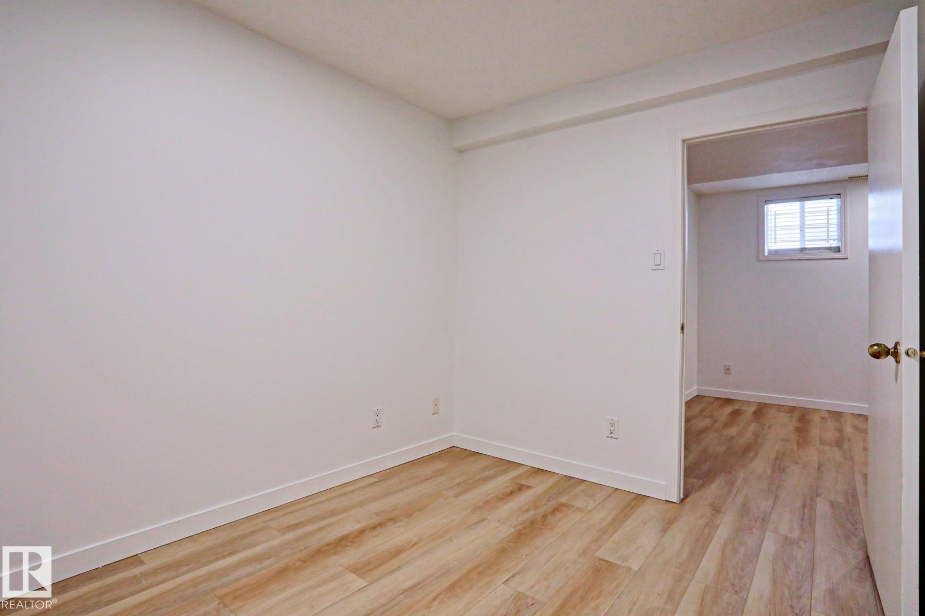 Room featuring light wood-finish flooring, white walls, and white trim - 9611 81 Avenue, Edmonton, AB - Indoor Photo Showing Other Room