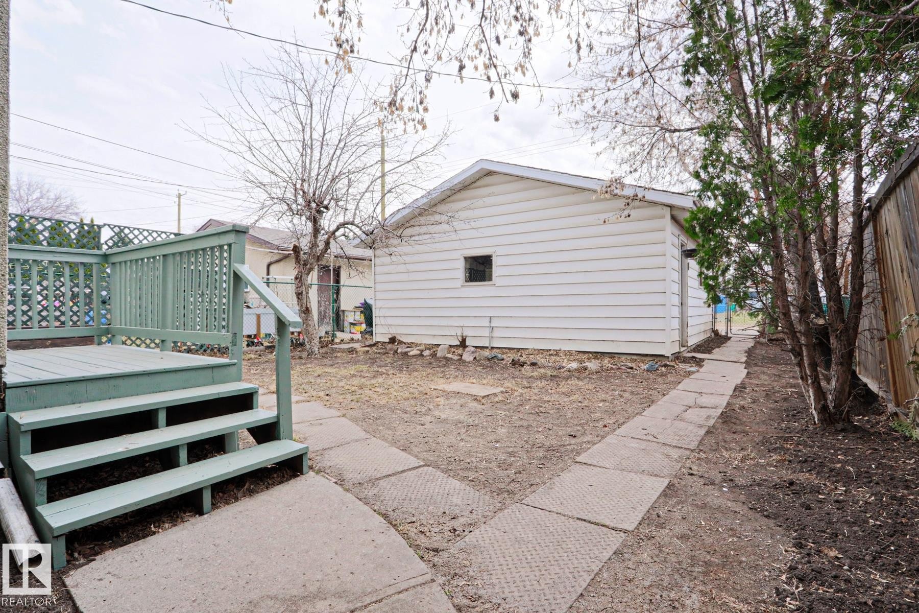 Exterior deck with green painted railings and lattice accents - 9611 81 Avenue, Edmonton, AB - Outdoor