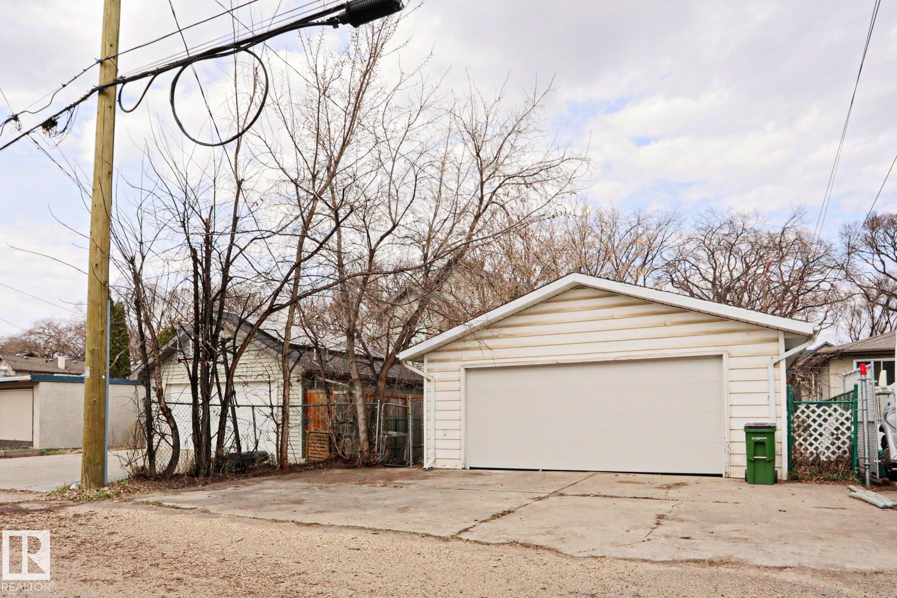 Detached garage with horizontal siding, a gable roof, and a single garage door - 9611 81 Avenue, Edmonton, AB - Outdoor