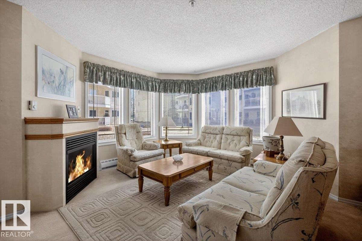 105 5212 25 Avenue Nw, Edmonton, AB - Indoor Photo Showing Living Room With Fireplace
