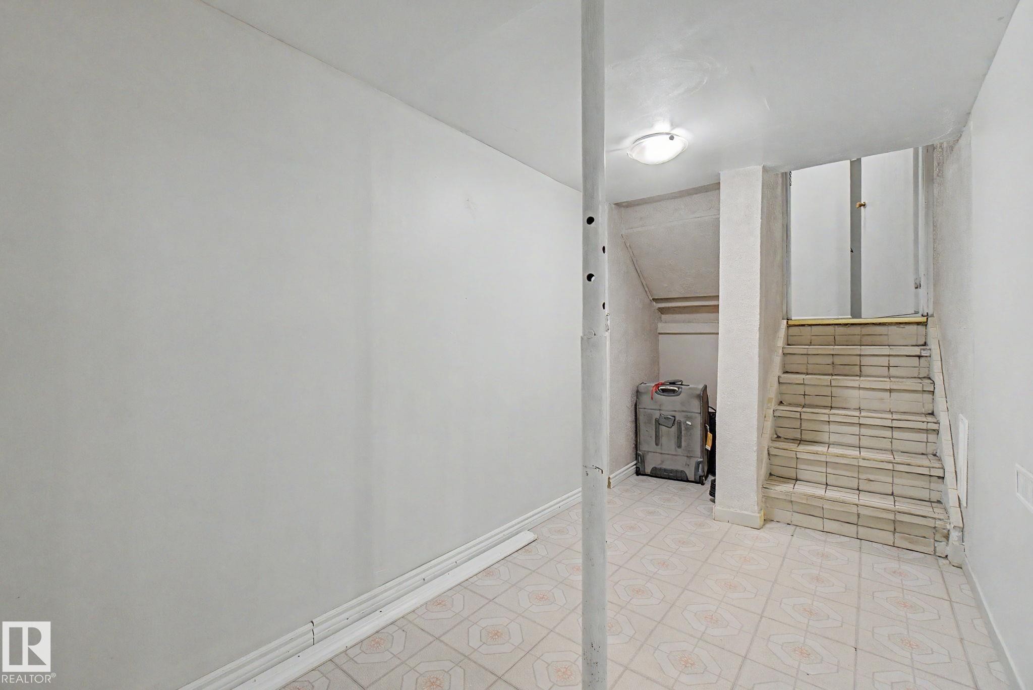 Tiled flooring throughout, featuring a staircase with tiled treads and risers - 4106 38 Street, Edmonton, AB - Indoor Photo Showing Other Room