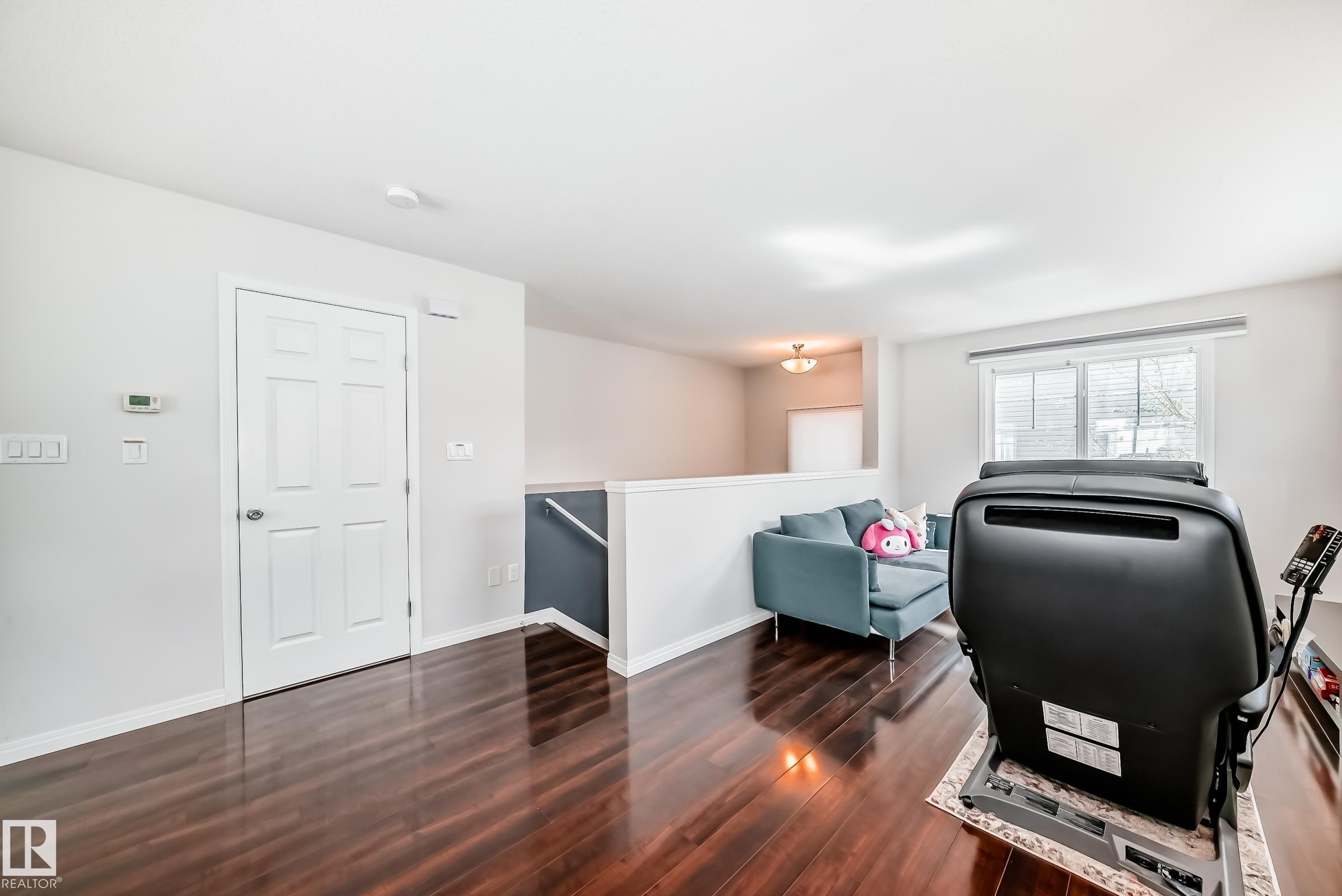 Rich wood-finish flooring extending throughout the space - 45 4850 Terwillegar Common, Edmonton, AB - Indoor