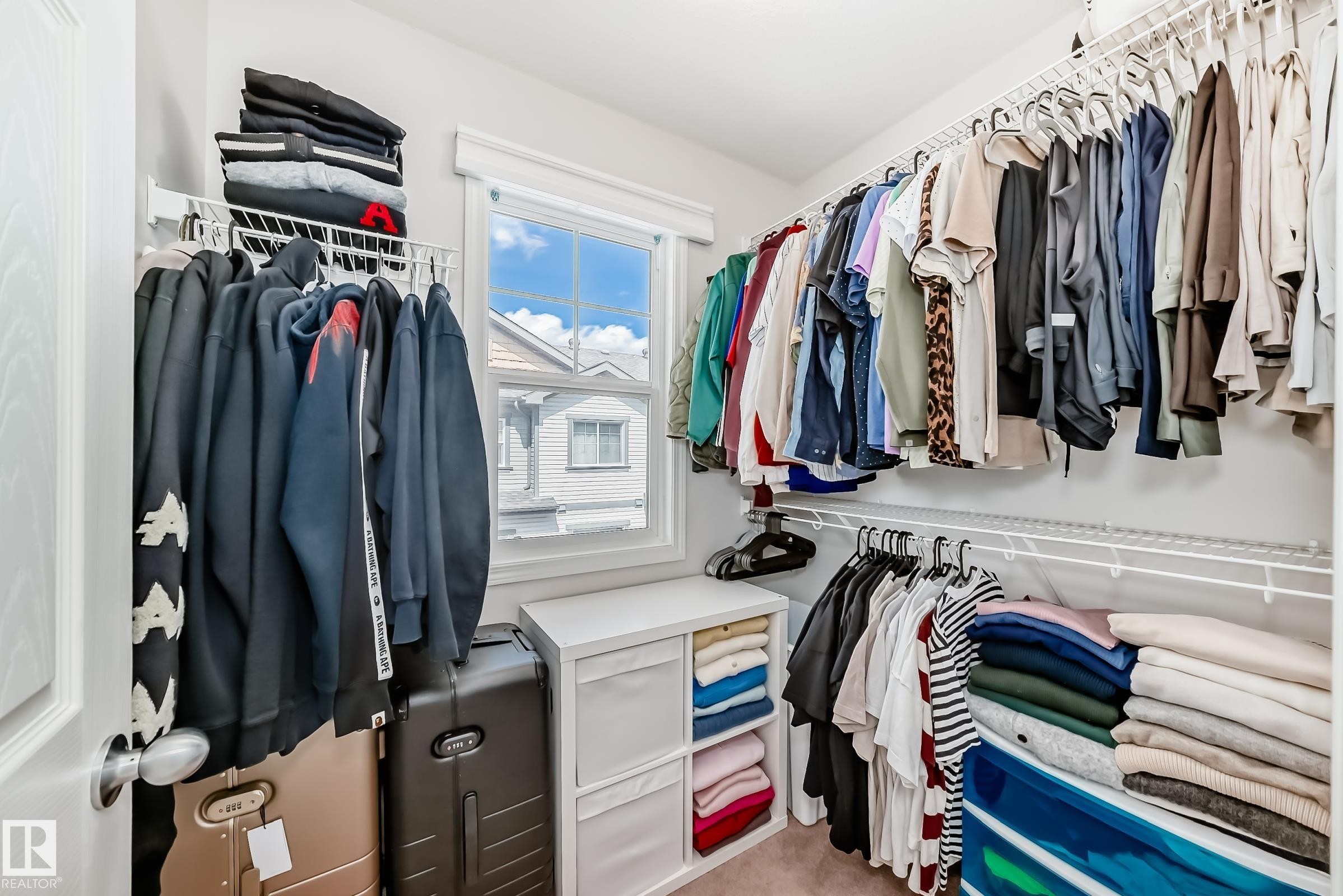 Walk-in closet with multiple levels of wire shelving and hanging rods - 45 4850 Terwillegar Common, Edmonton, AB - Indoor With Storage