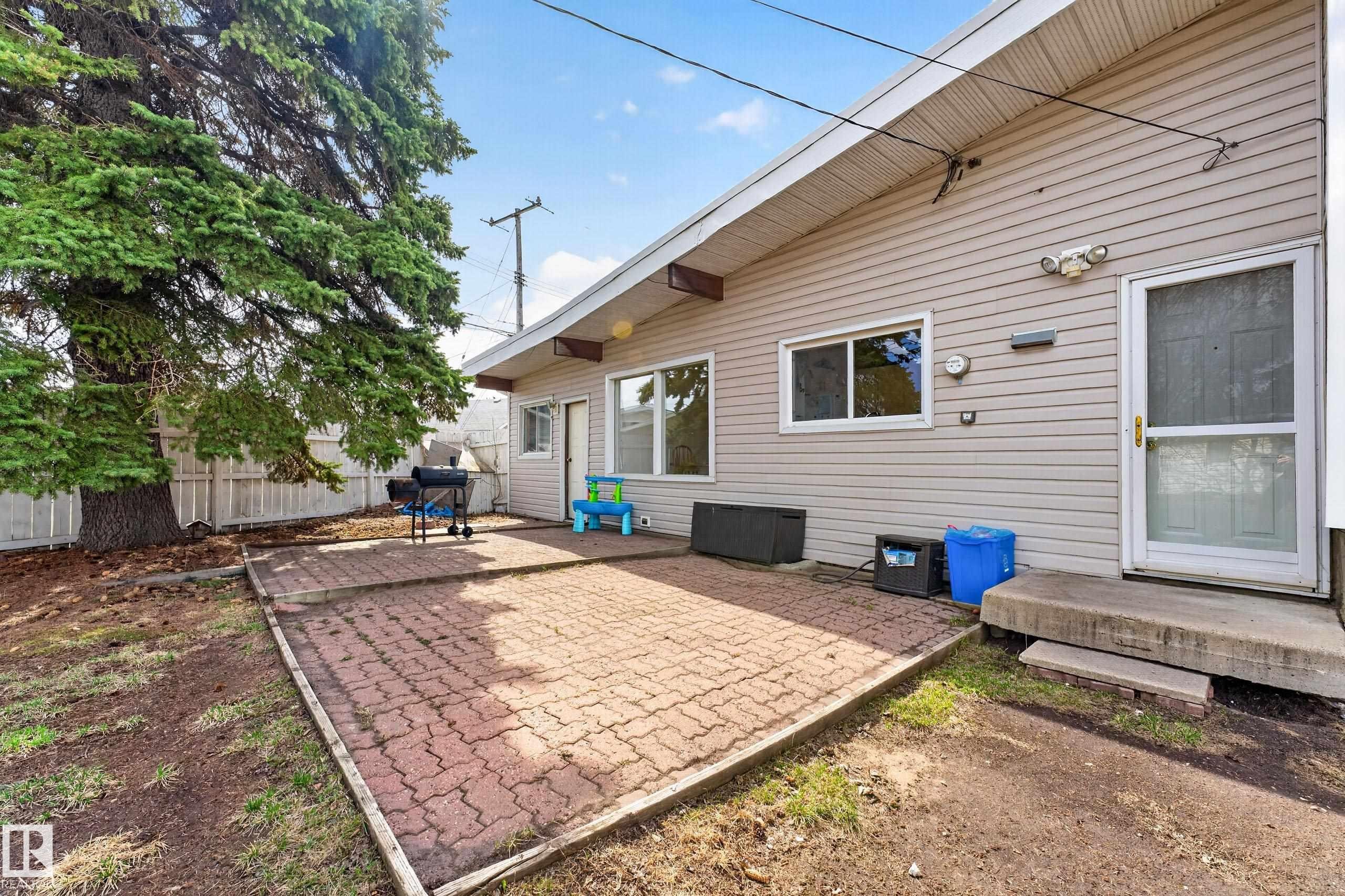 Exterior siding with multiple windows and an entry door - 5304 90A Avenue, Edmonton, AB - Outdoor With Exterior