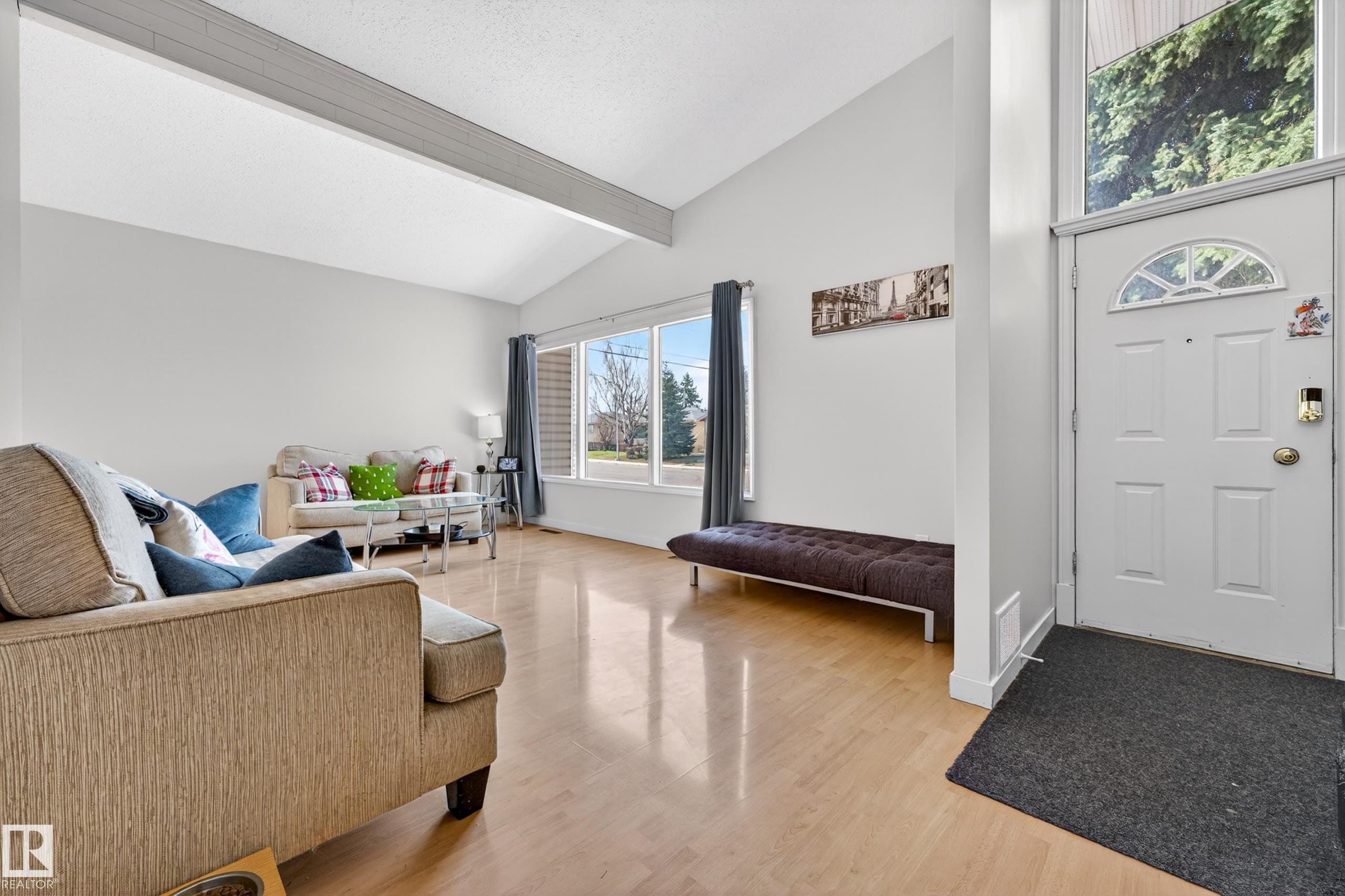 Vaulted ceilings featuring exposed beams, light wood-finish flooring, and expansive windows - 5304 90A Avenue, Edmonton, AB - Indoor