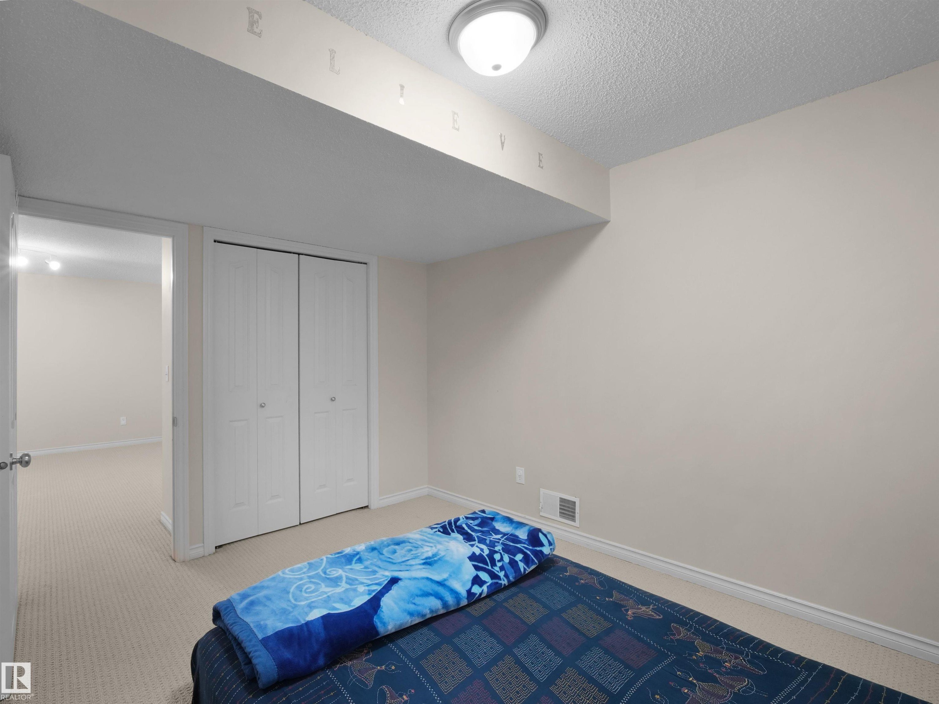 Neutral-toned walls complement the light beige carpet flooring - 7407 Singer Landing, Edmonton, AB - Indoor Photo Showing Bedroom