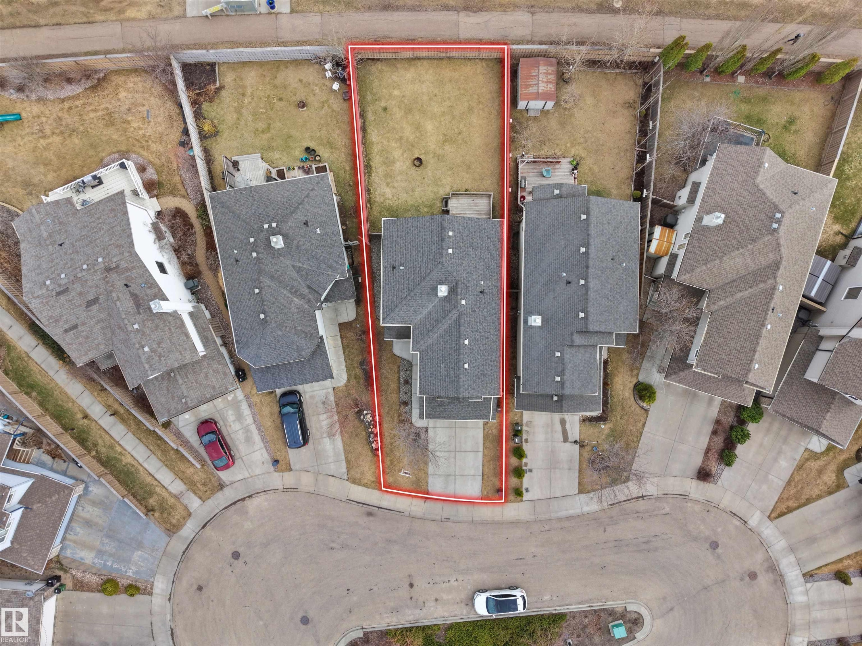 Aerial view showcasing a residential property with a shingled roof, a paved driveway, and an expansive grassy backyard - 7407 Singer Landing, Edmonton, AB - With View