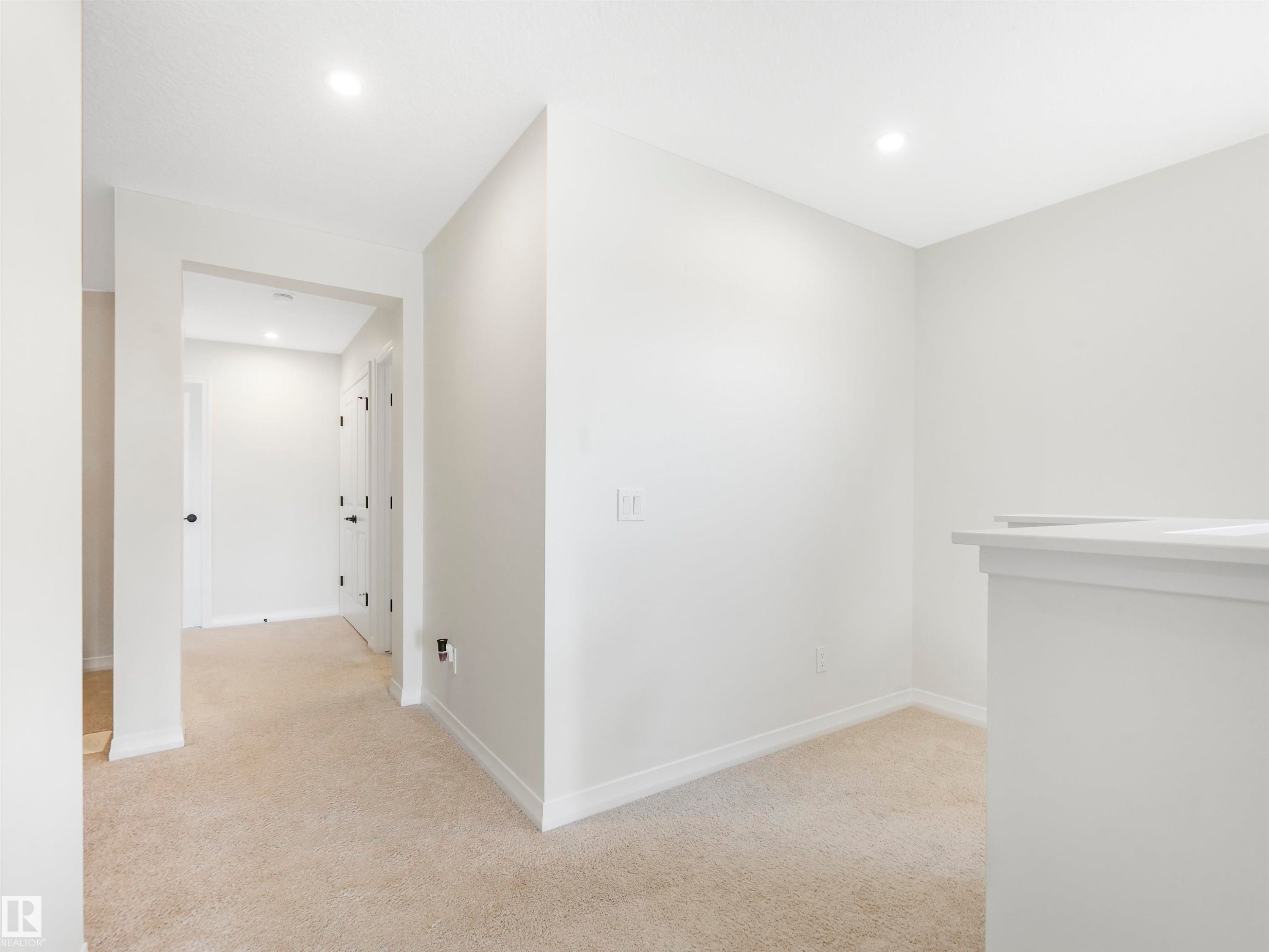 This property features light-colored carpet, white walls, and recessed lighting - 19 Nettle Crescent, St. Albert, AB - Indoor Photo Showing Other Room