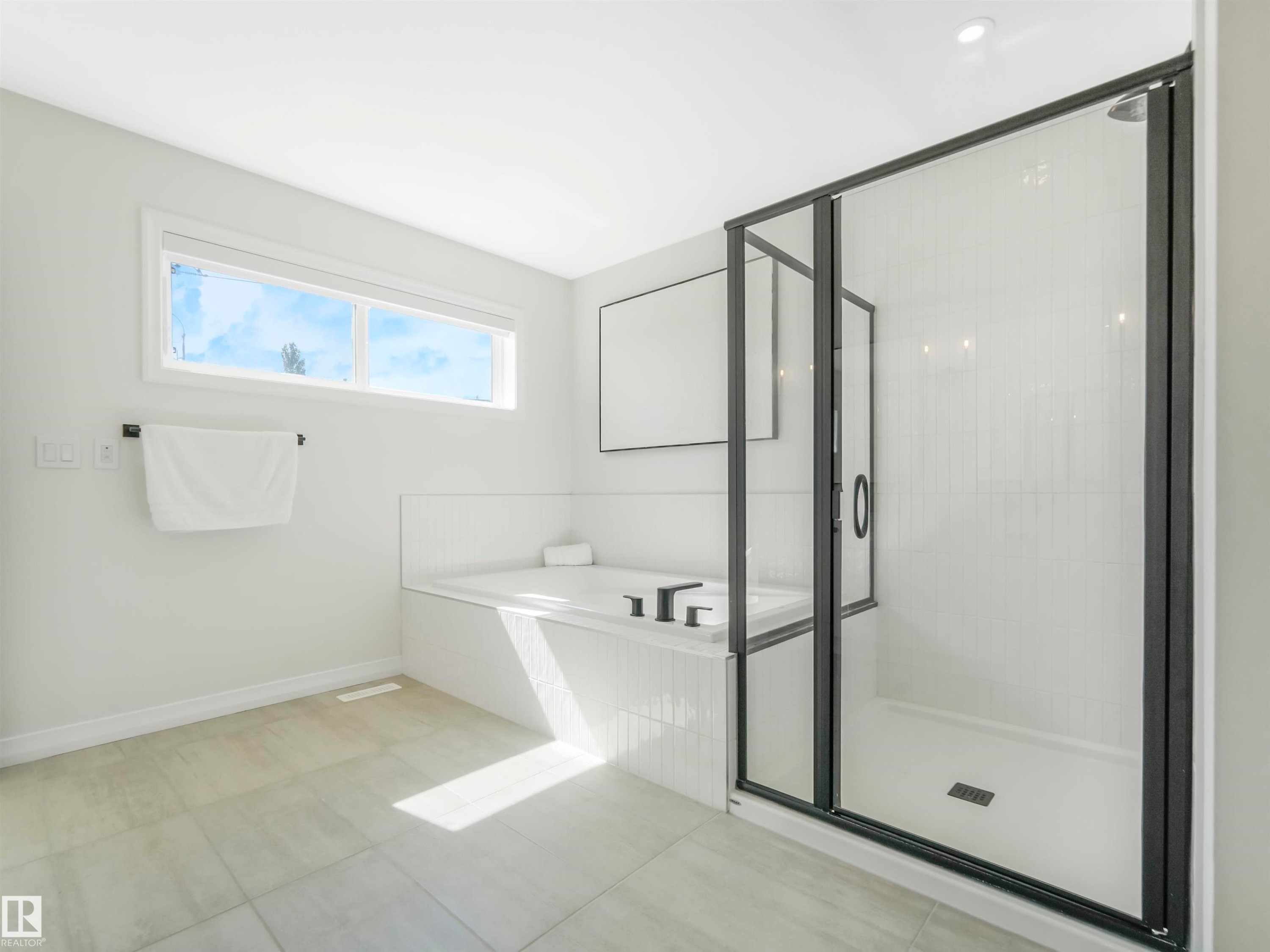The bathroom features a built-in bathtub, a walk-in shower with a glass enclosure, and a horizontal window - 19 Nettle Crescent, St. Albert, AB - Indoor Photo Showing Bathroom