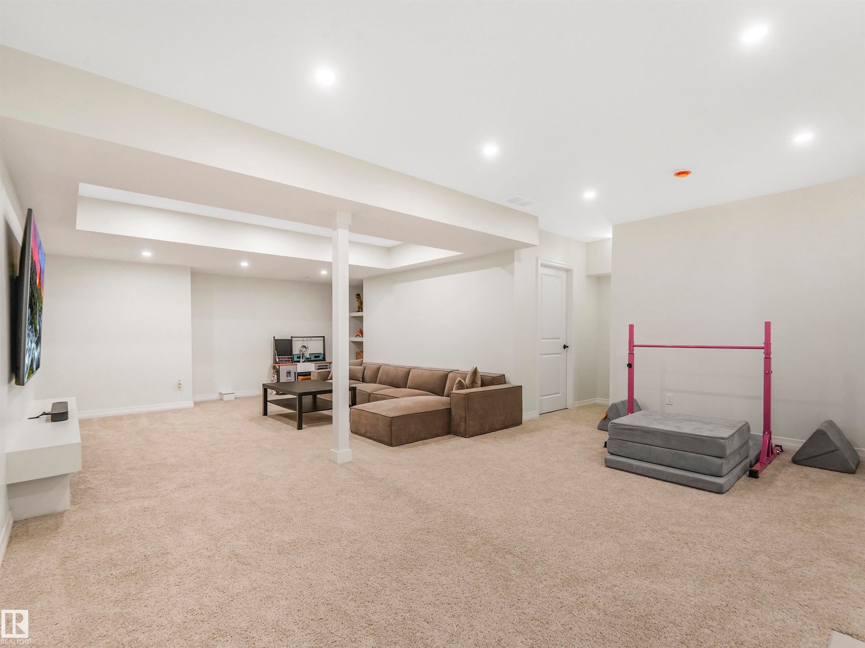 Spacious room featuring light-colored carpeting, recessed lighting, and white walls - 19 Nettle Crescent, St. Albert, AB - Indoor