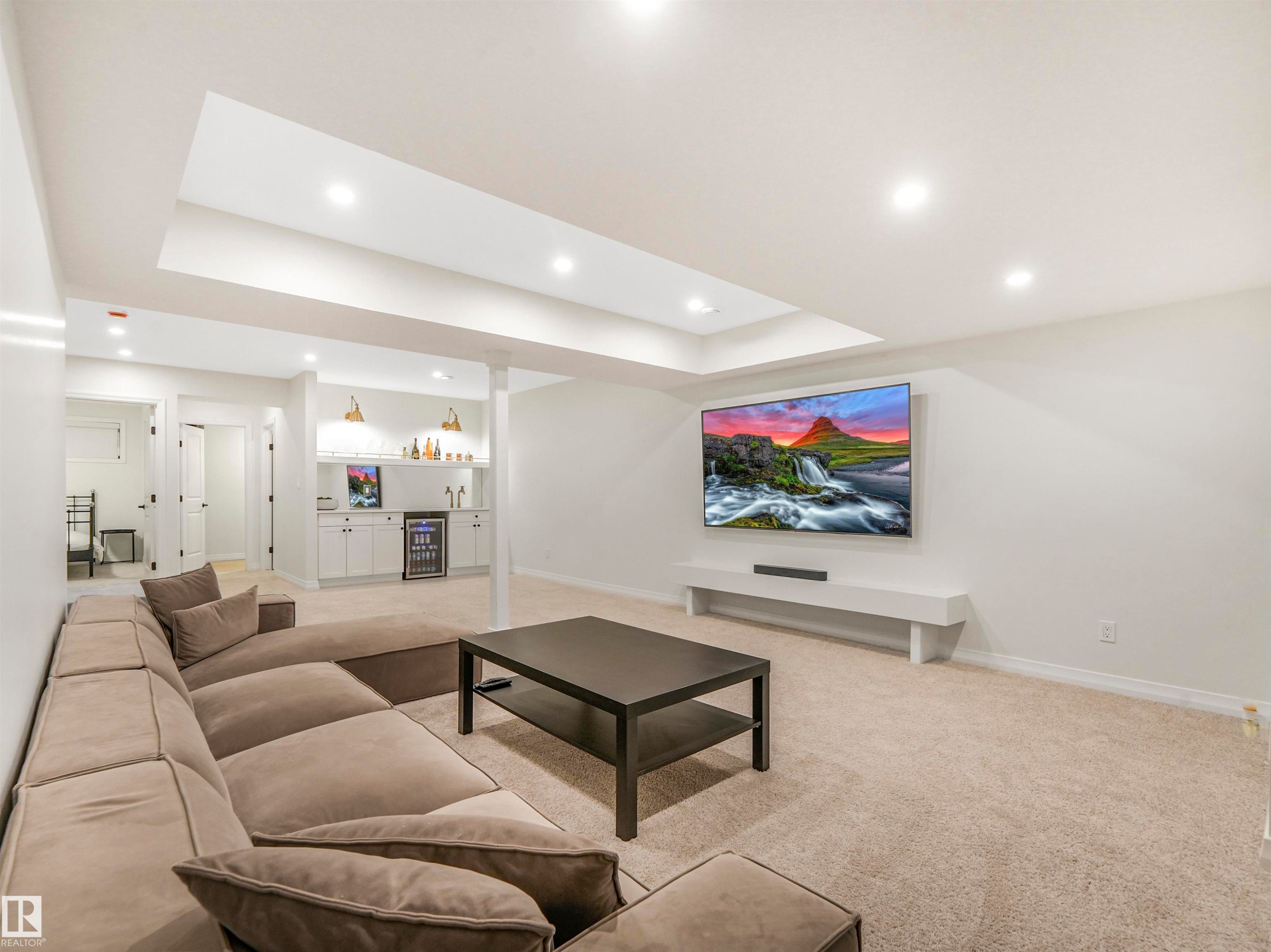 The room features recessed lighting, a built-in media console, and a wet bar with white cabinetry and shelving - 19 Nettle Crescent, St. Albert, AB - Indoor