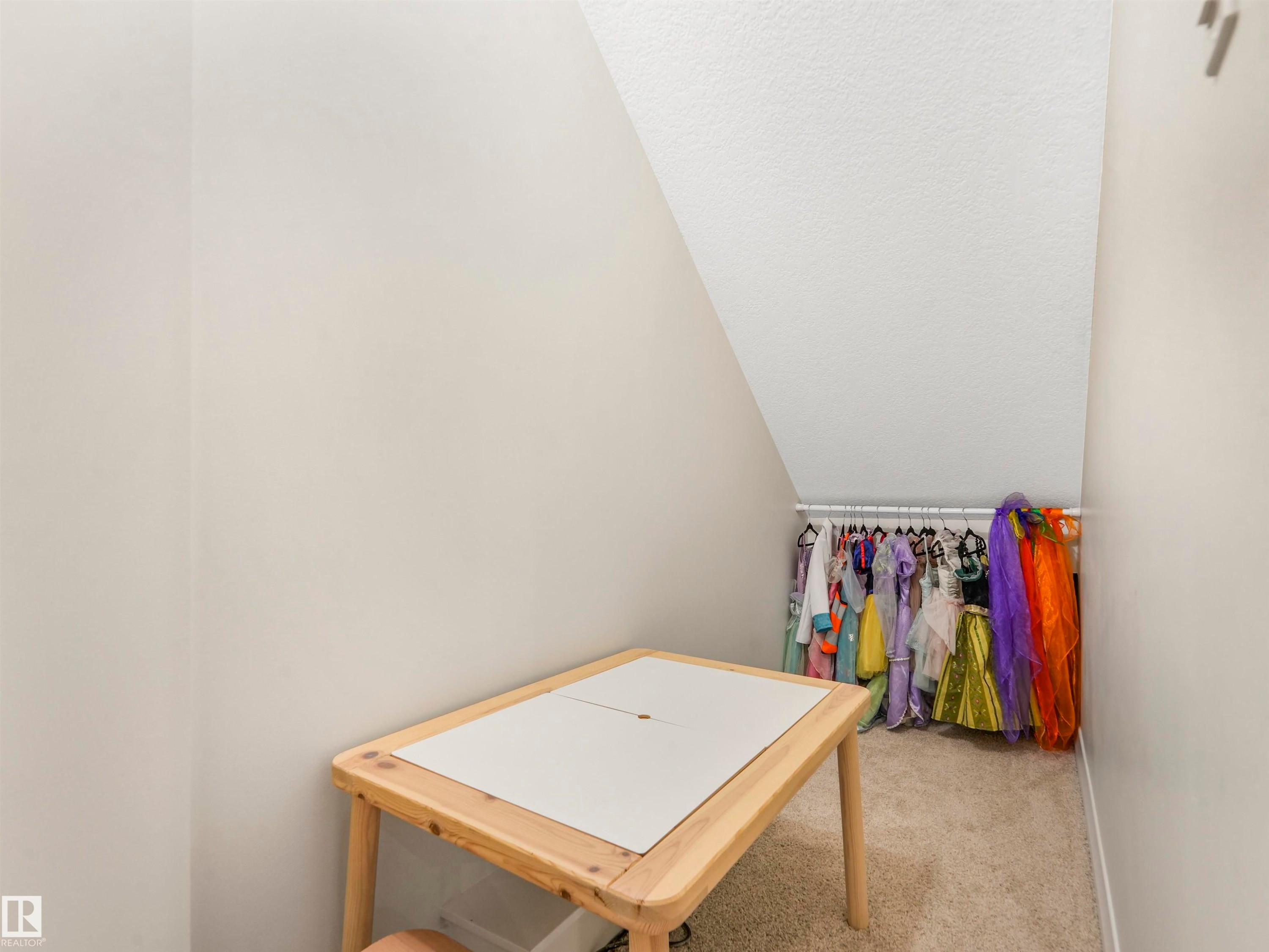 This property offers a versatile space with sloped ceilings and light beige walls, providing a neutral canvas - 19 Nettle Crescent, St. Albert, AB - Indoor Photo Showing Other Room