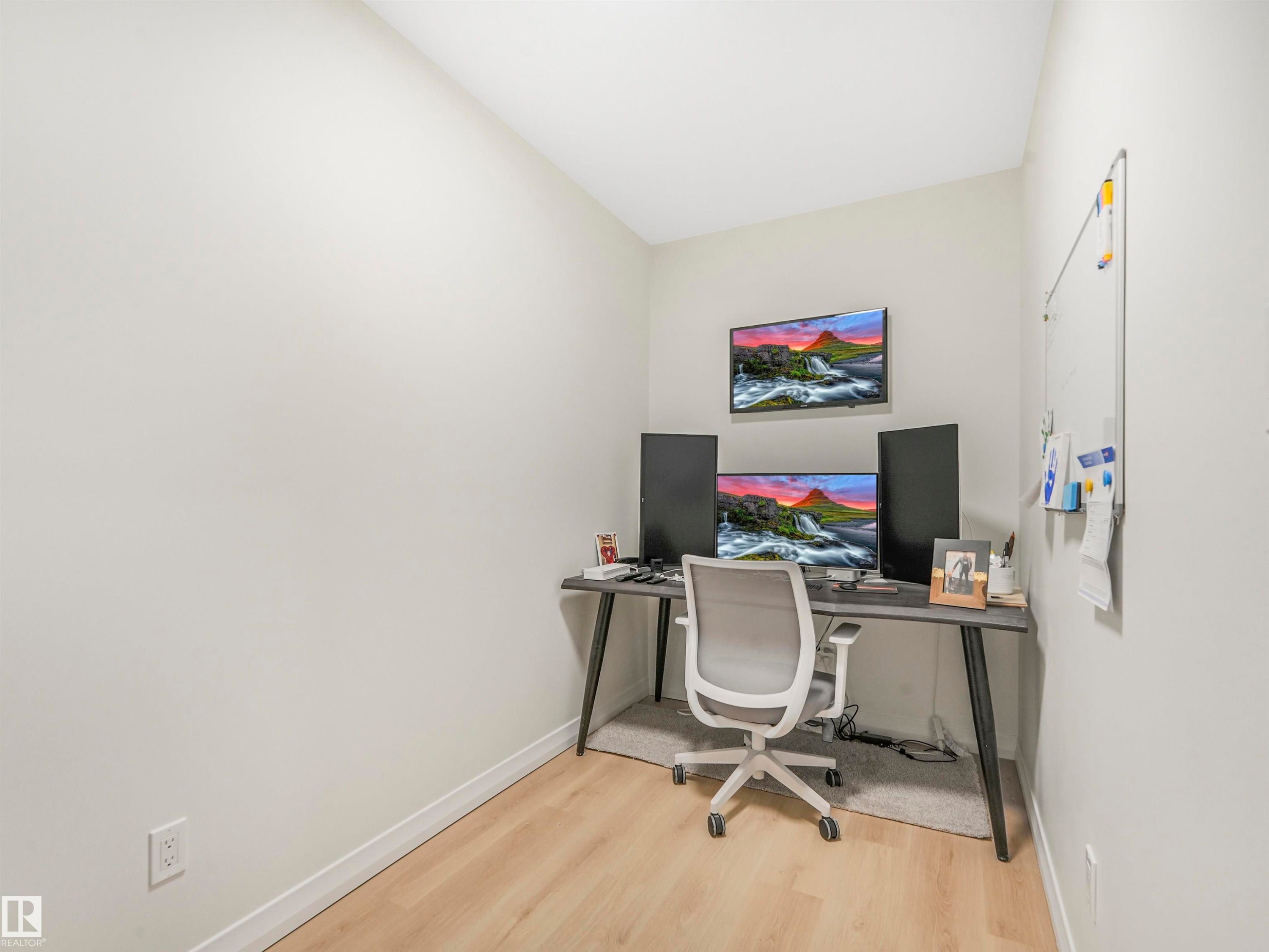 Dedicated office space featuring light wood flooring and a wall-mounted whiteboard - 19 Nettle Crescent, St. Albert, AB - Indoor Photo Showing Office
