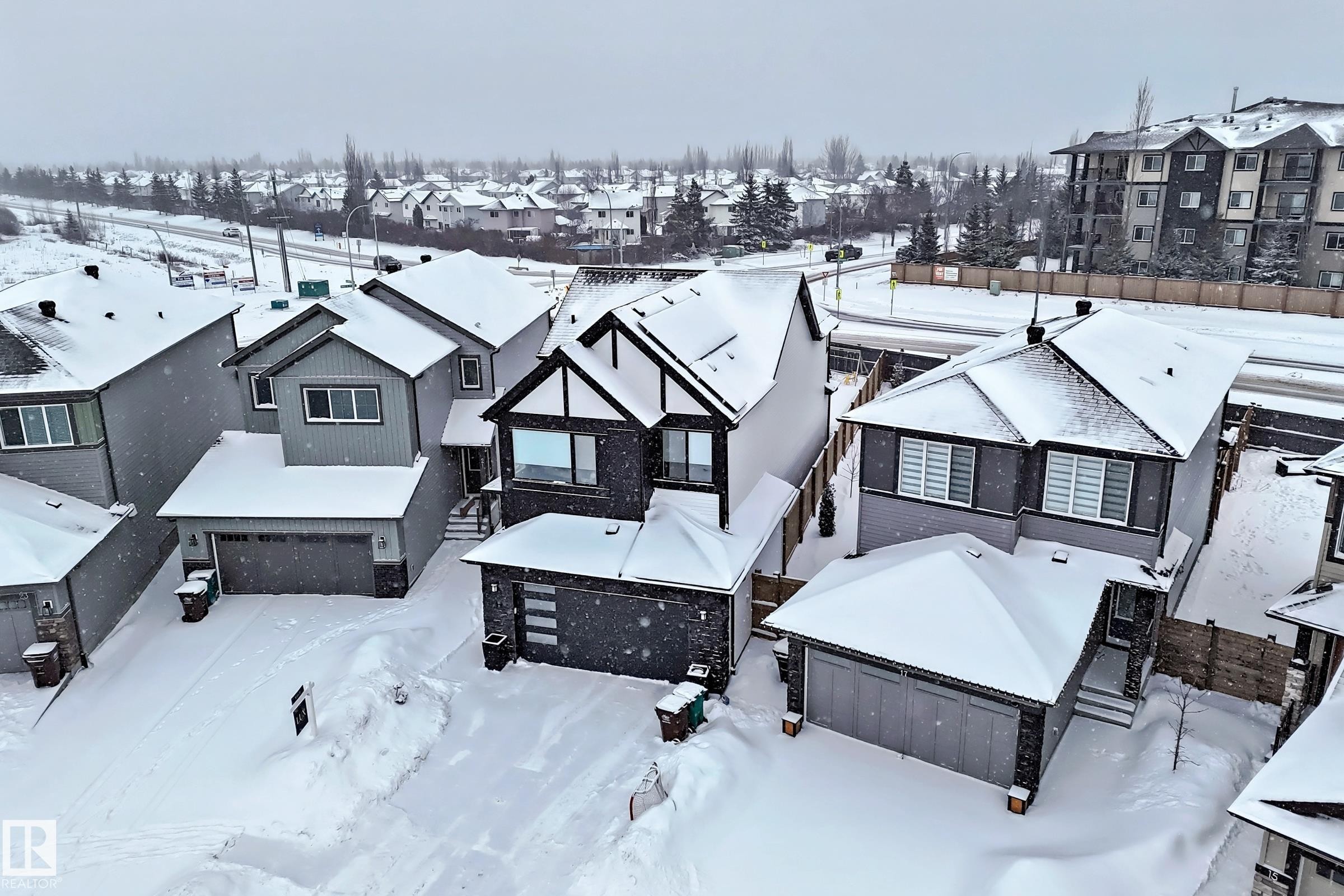 This property features a contemporary exterior design with an attached garage - 19 Nettle Crescent, St. Albert, AB - Outdoor With Deck Patio Veranda