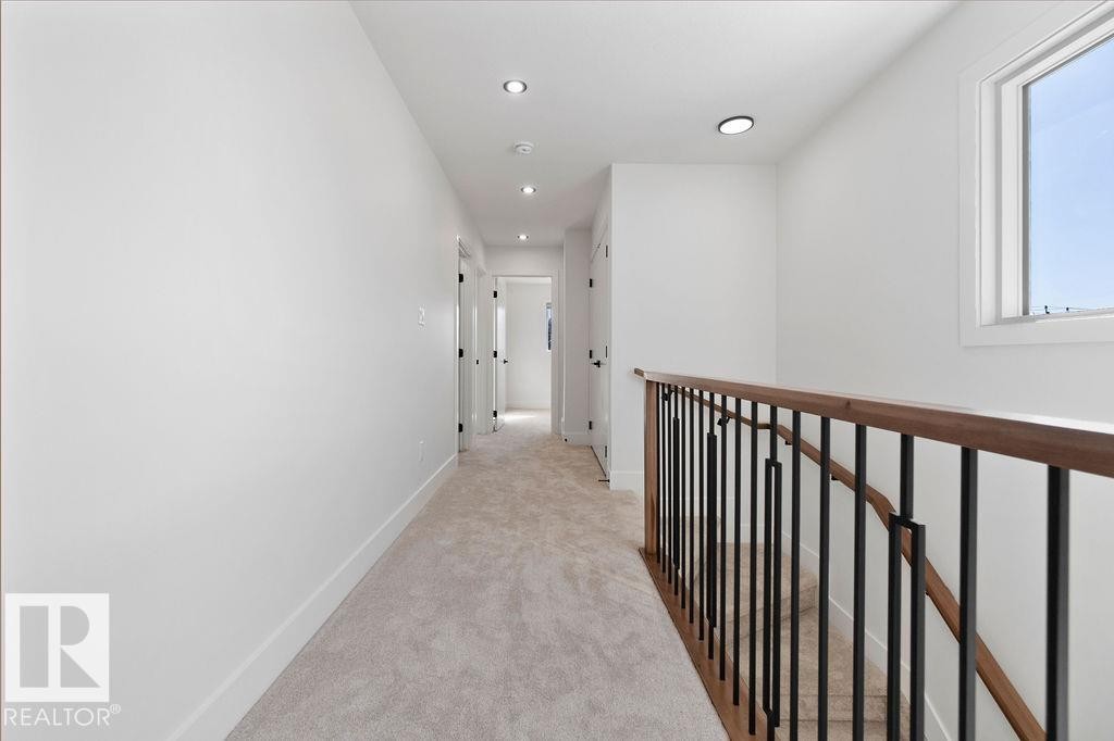 Hallway featuring light-colored carpeting, recessed lighting, and white walls - 12307 91 St Nw, Edmonton, AB - Indoor Photo Showing Other Room