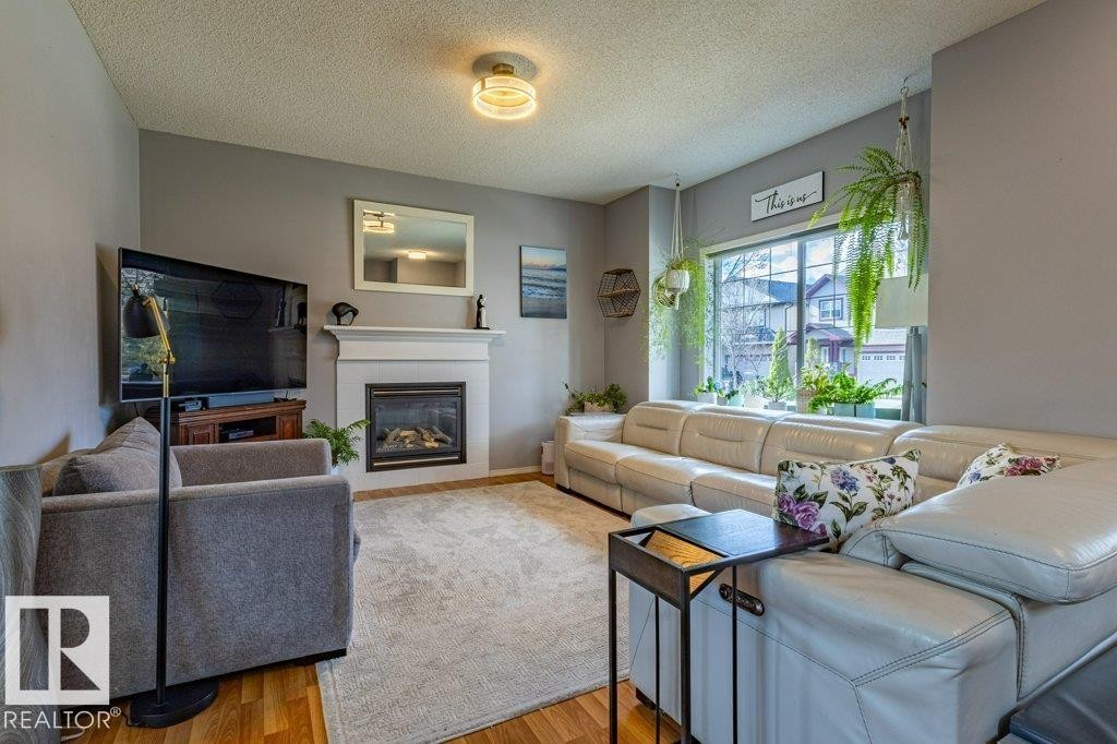 1676 Tomlinson Common, Edmonton, AB - Indoor Photo Showing Living Room With Fireplace
