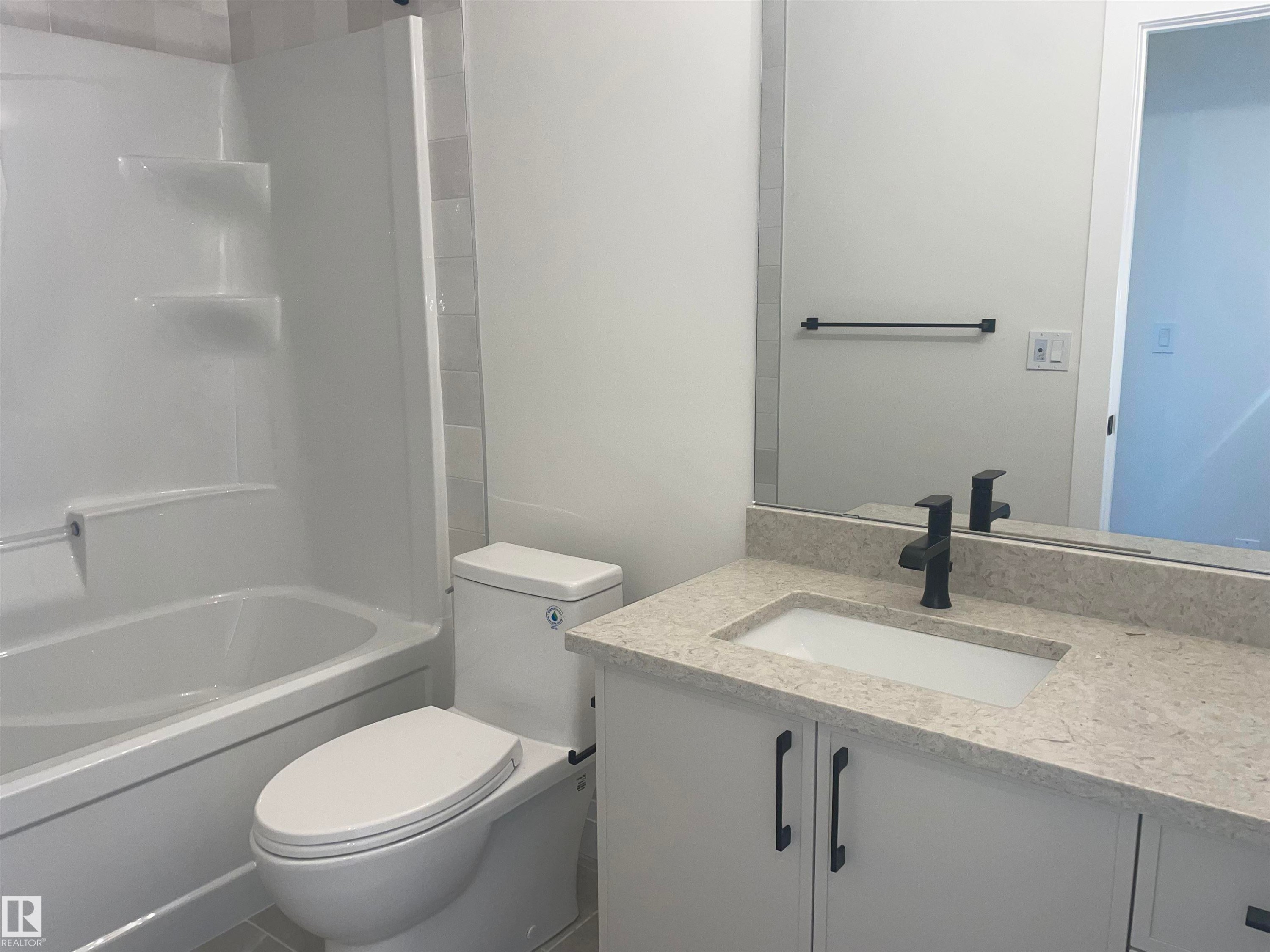 Spacious room featuring light wood-finish flooring, white baseboards, and a large three-panel window with white trim - 14344 92A Avenue, Edmonton, AB - Indoor Photo Showing Other Room