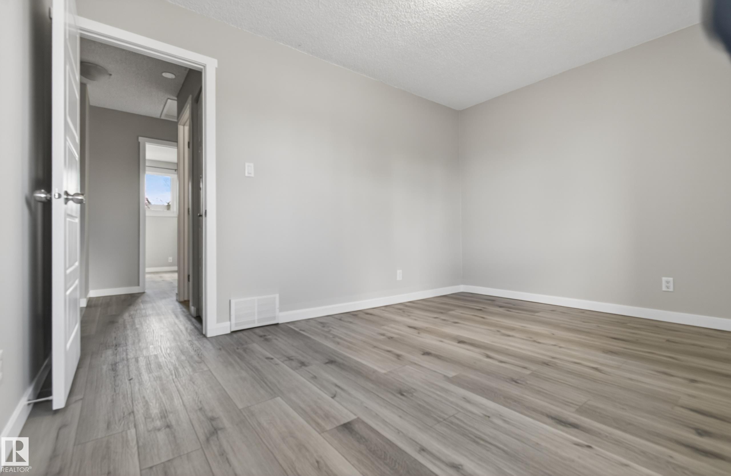 Light gray wood-finish flooring - 18 Lakewood Village, Edmonton, AB - Indoor Photo Showing Other Room