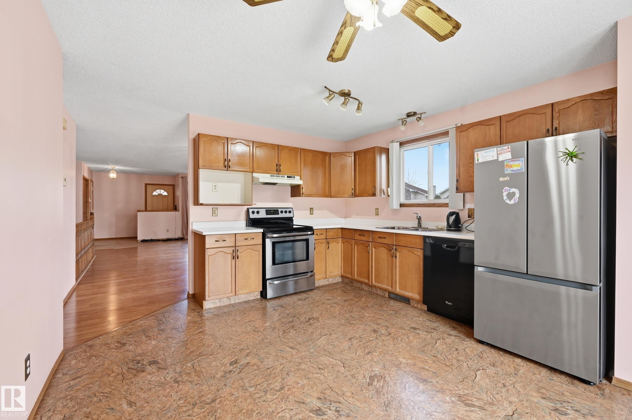 Kitchen featuring wood cabinetry, stainless steel appliances, and a window above the sink - 1242 Joyce Crescent, Edmonton, AB - Indoor Photo Showing Kitchen With Double Sink