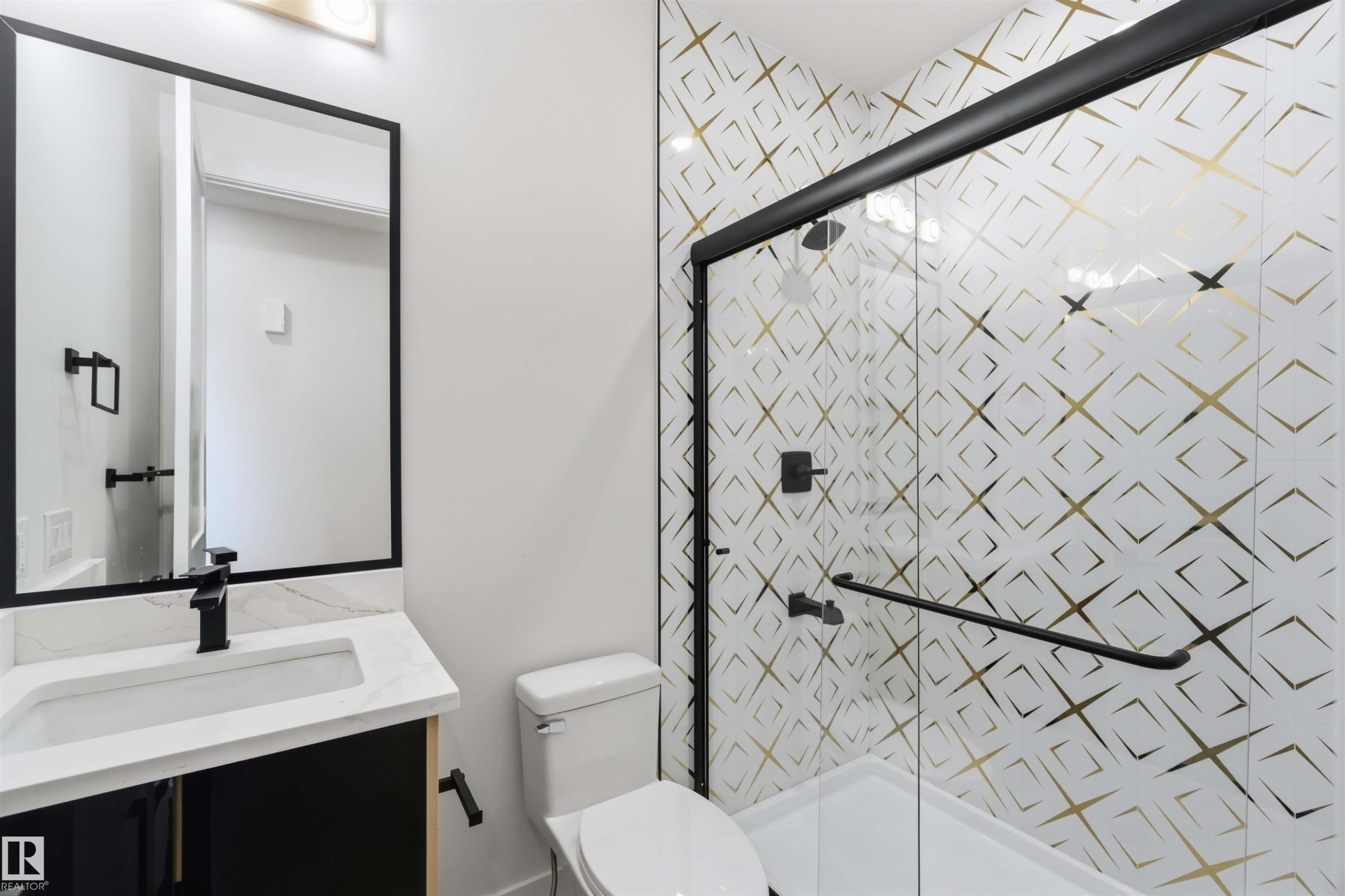 Bathroom featuring a walk-in shower with patterned tile, glass enclosure, and matte black fixtures - 417 Pine Point(E), Leduc, AB - Indoor Photo Showing Bathroom