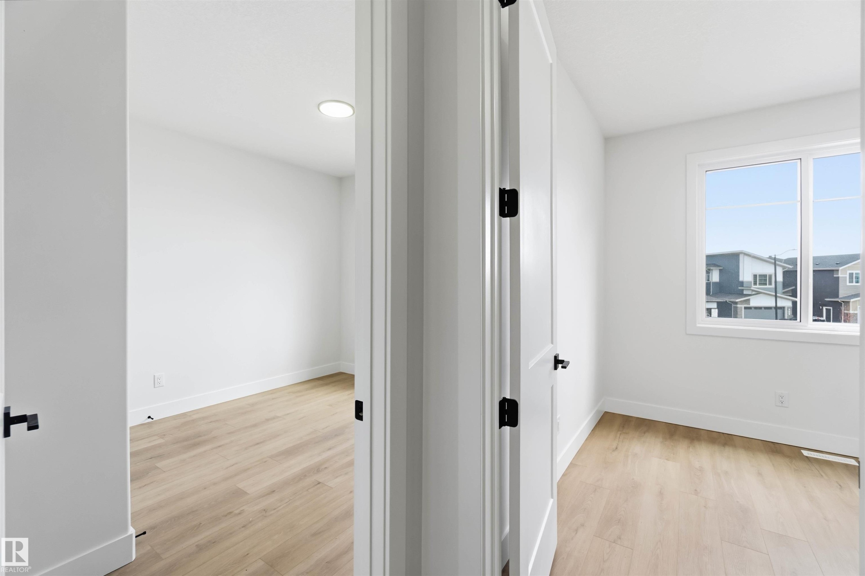 Interior space featuring light wood-finish flooring and white walls - 417 Pine Point(E), Leduc, AB - Indoor Photo Showing Other Room