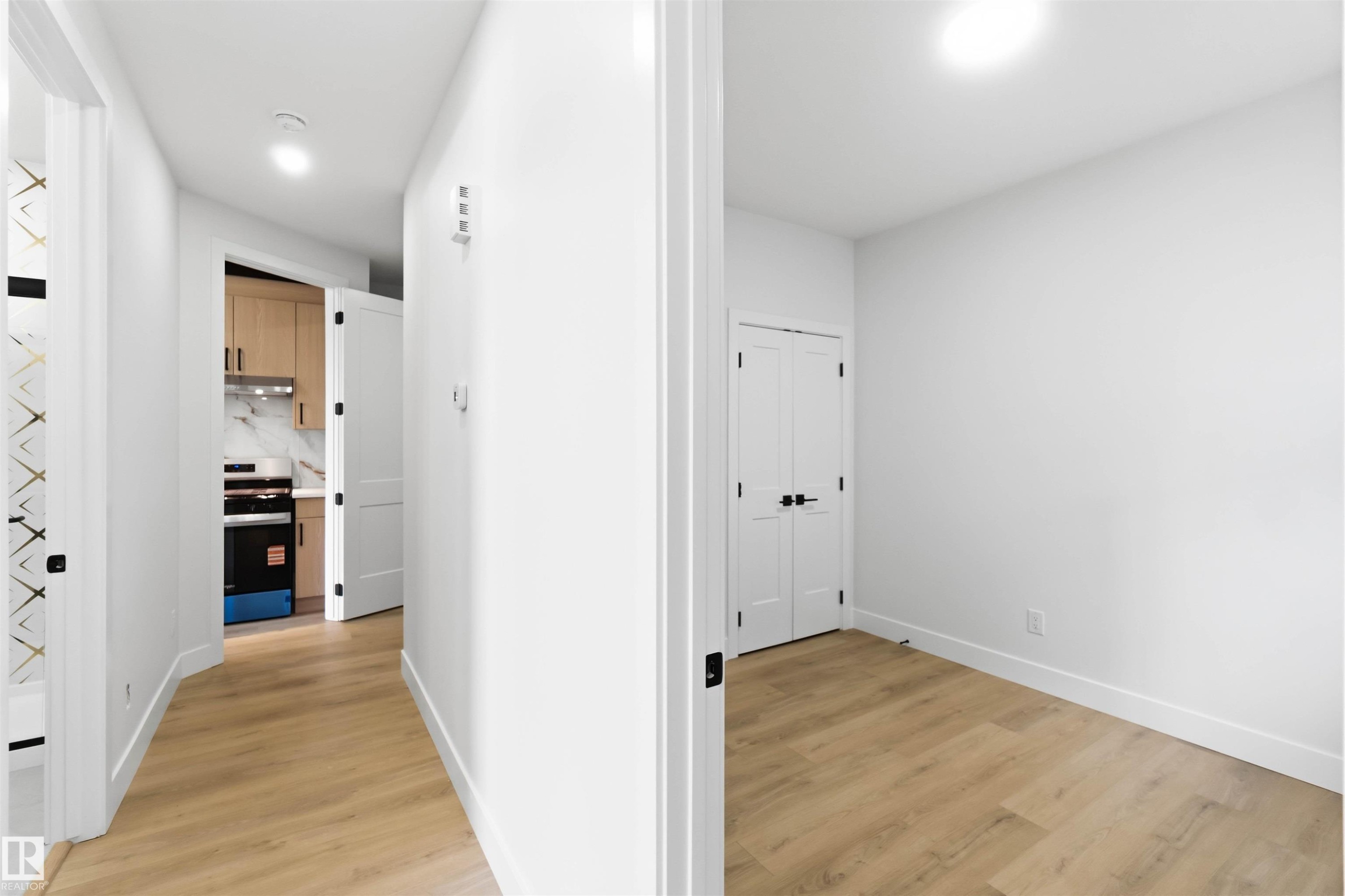 Hallway featuring wood-finish flooring and white baseboards - 417 Pine Point(E), Leduc, AB - Indoor Photo Showing Other Room