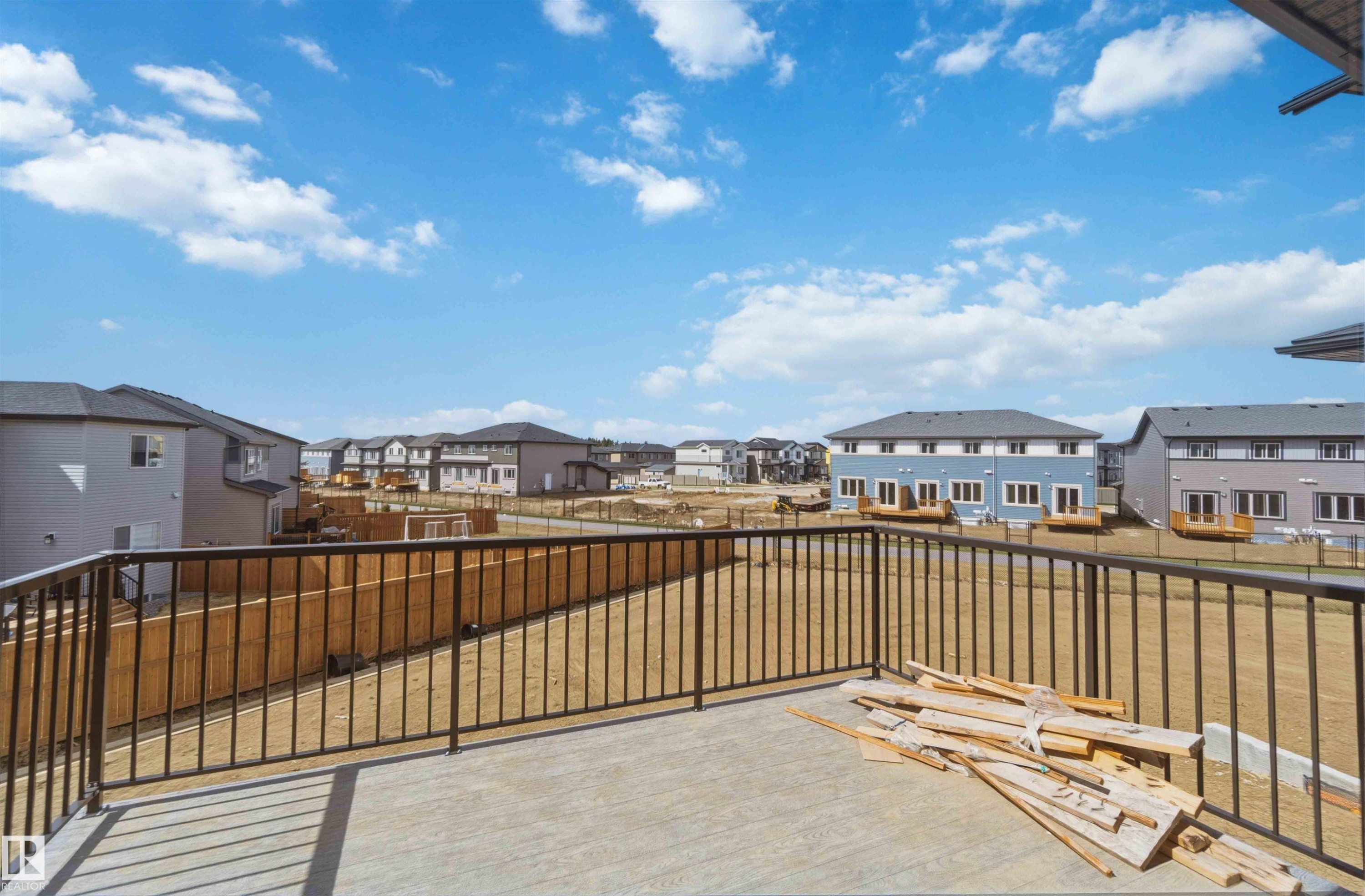Concrete balcony with black metal railing - 417 Pine Point(E), Leduc, AB - Outdoor With Exterior