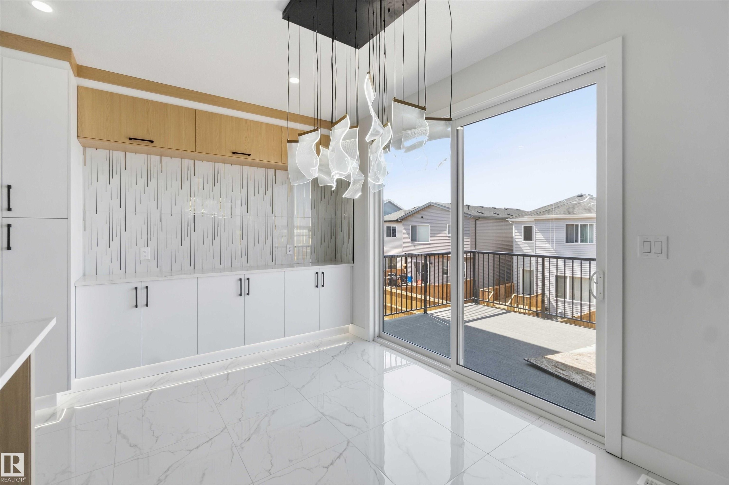 Modern interior space featuring large format marble-look tile flooring - 415 Pine Point(E), Leduc, AB - With Exterior