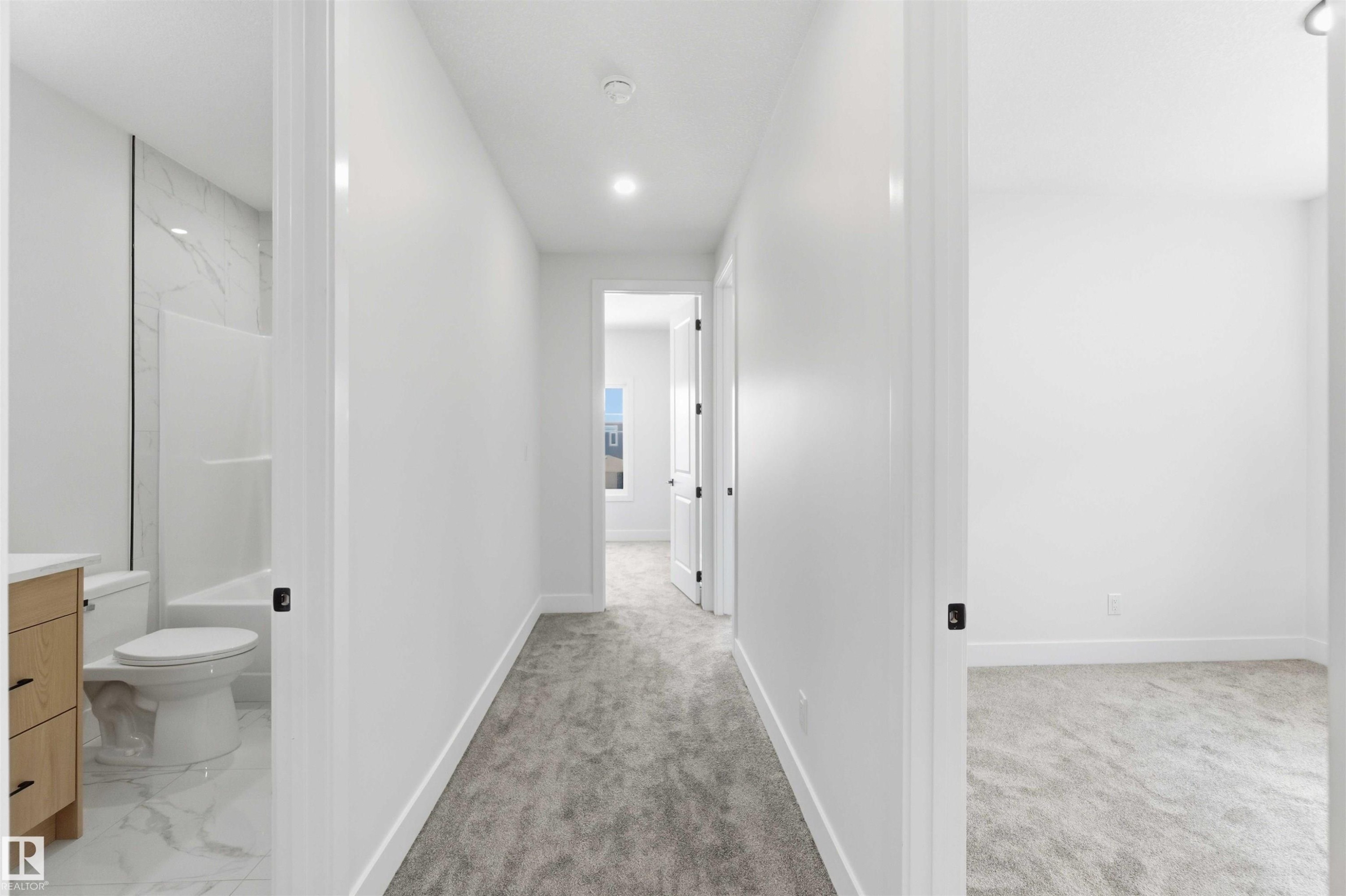 Hallway featuring light gray carpet, recessed lighting, and white walls - 415 Pine Point(E), Leduc, AB - Indoor