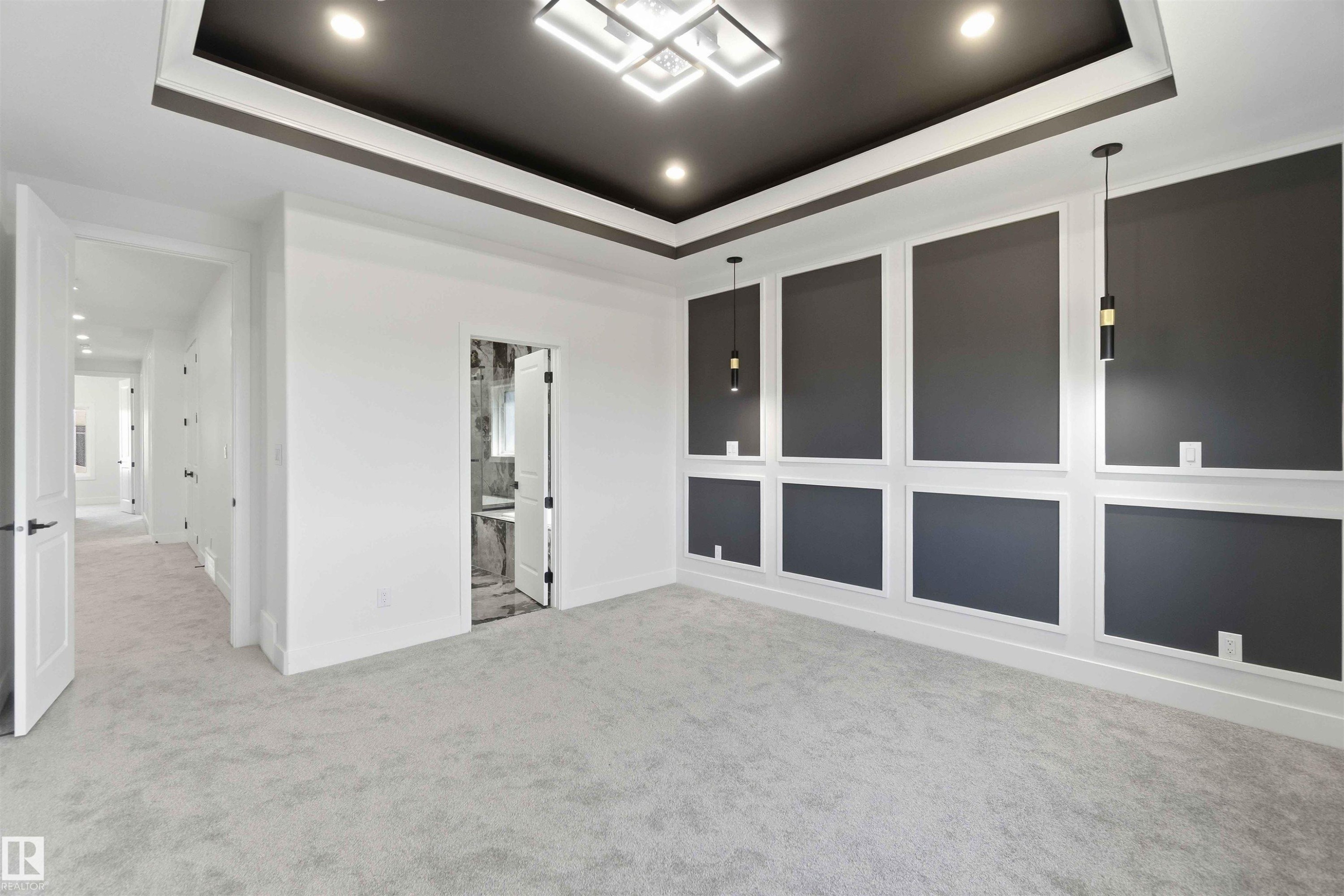 Recessed ceiling with integrated lighting and a central modern chandelier - 415 Pine Point(E), Leduc, AB - Indoor Photo Showing Other Room