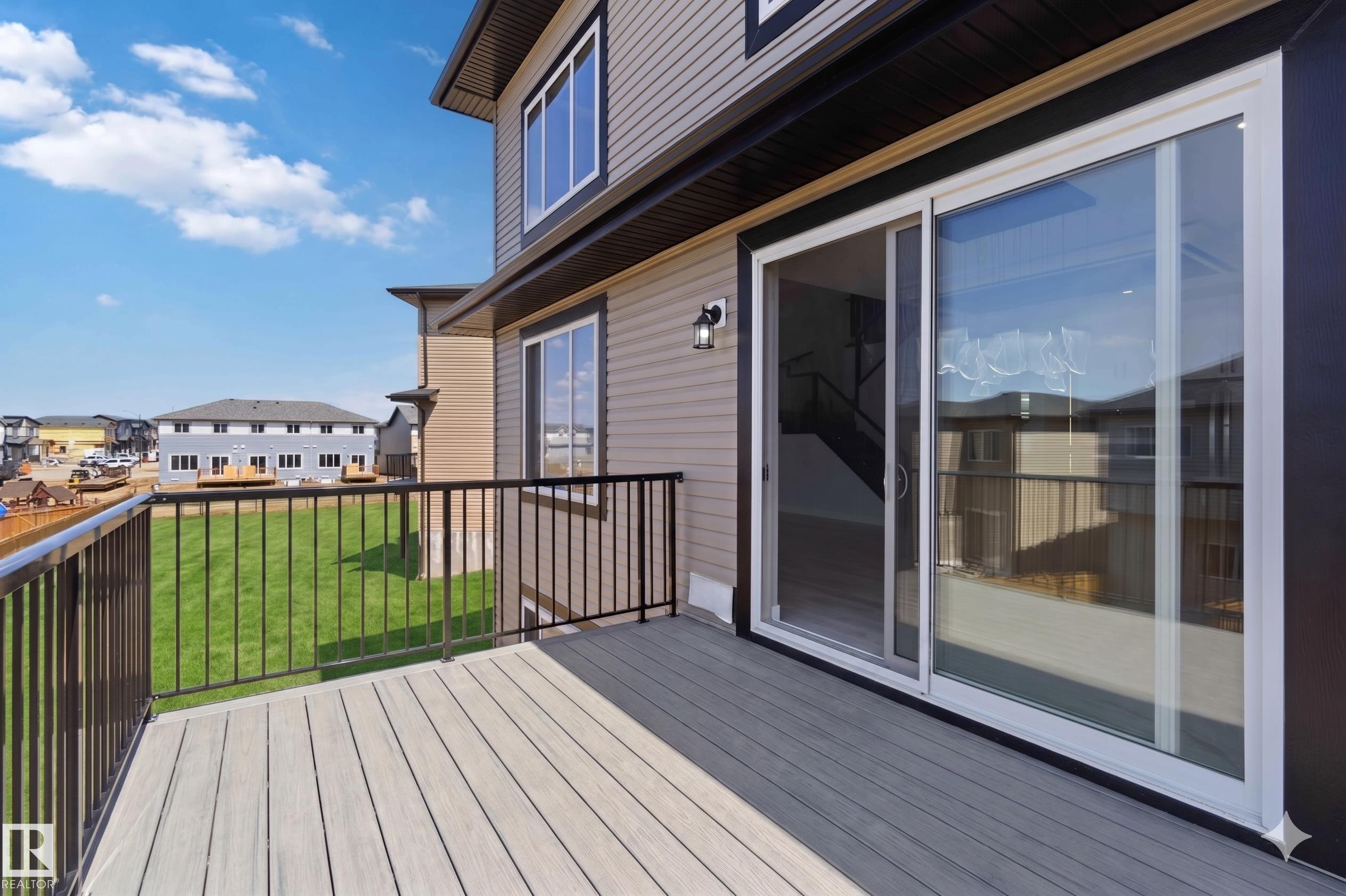 Spacious deck with composite decking and black metal railings - 415 Pine Point(E), Leduc, AB - Outdoor With Deck Patio Veranda With Exterior