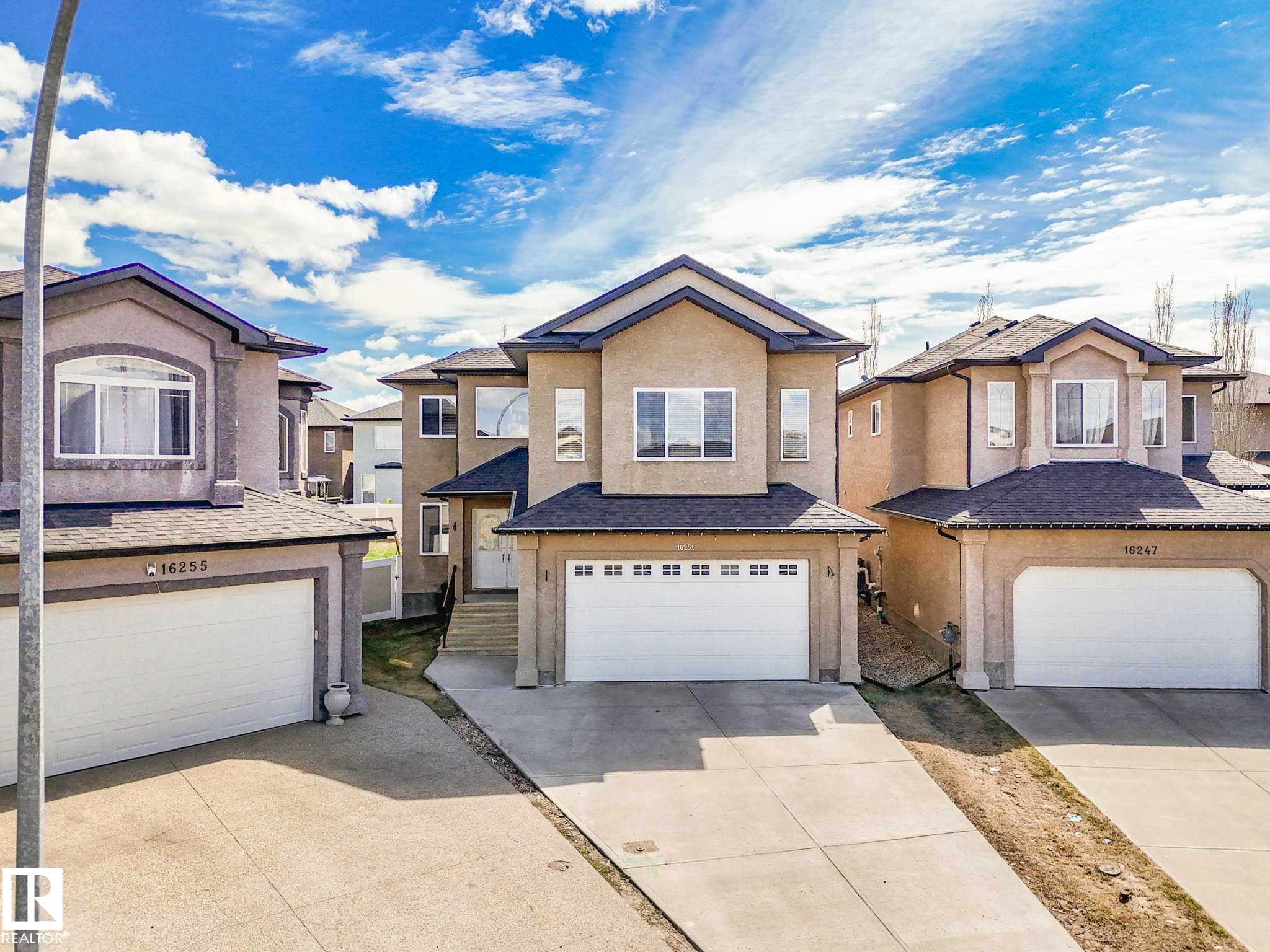 Two-story stucco residence featuring a dual-pitch roofline - 16251 135 Street Nw, Edmonton, AB - Outdoor With Facade