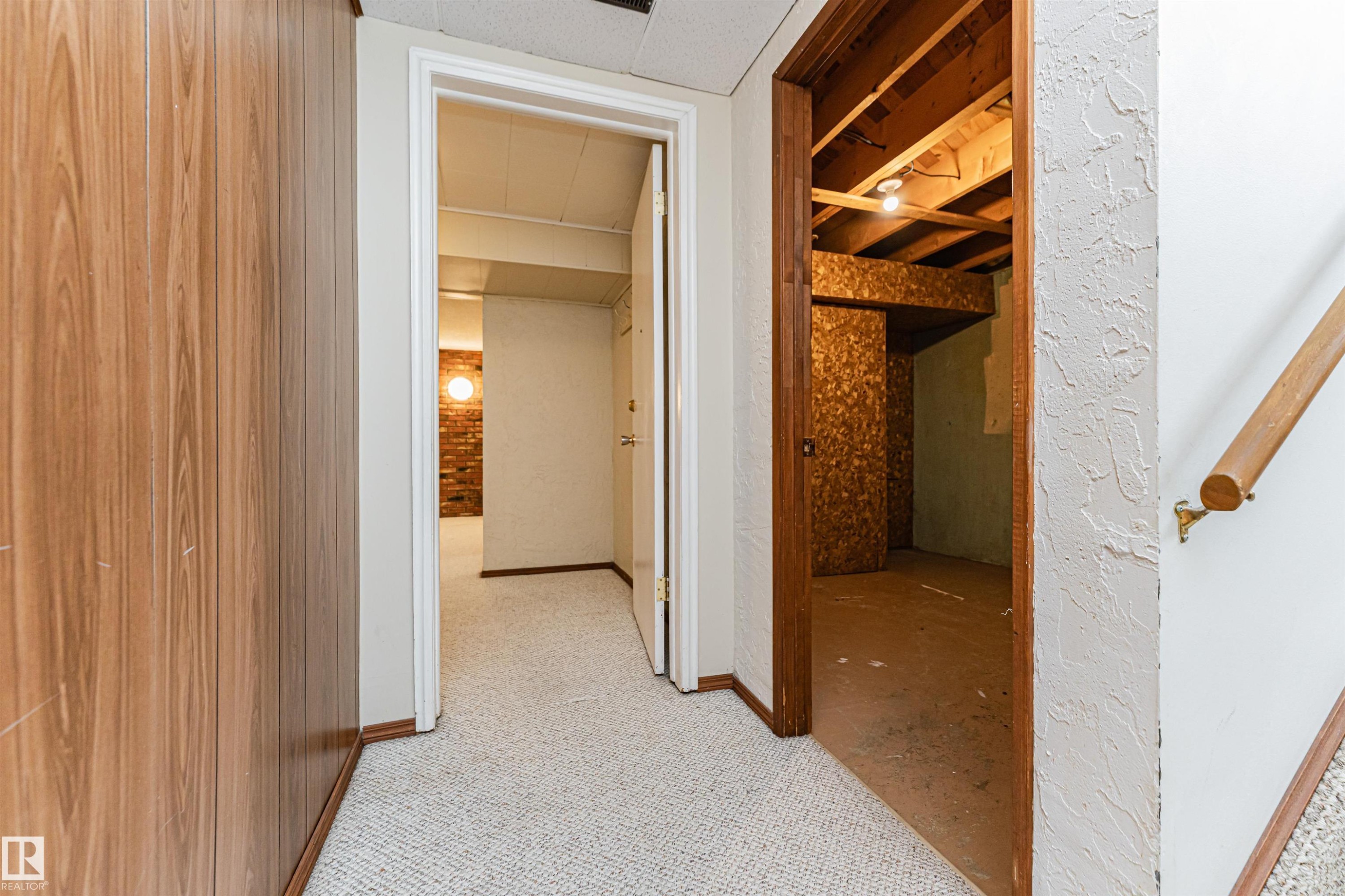 Wood-finish paneling and white textured walls define this interior space - 11423 50 Avenue, Edmonton, AB - Indoor Photo Showing Other Room