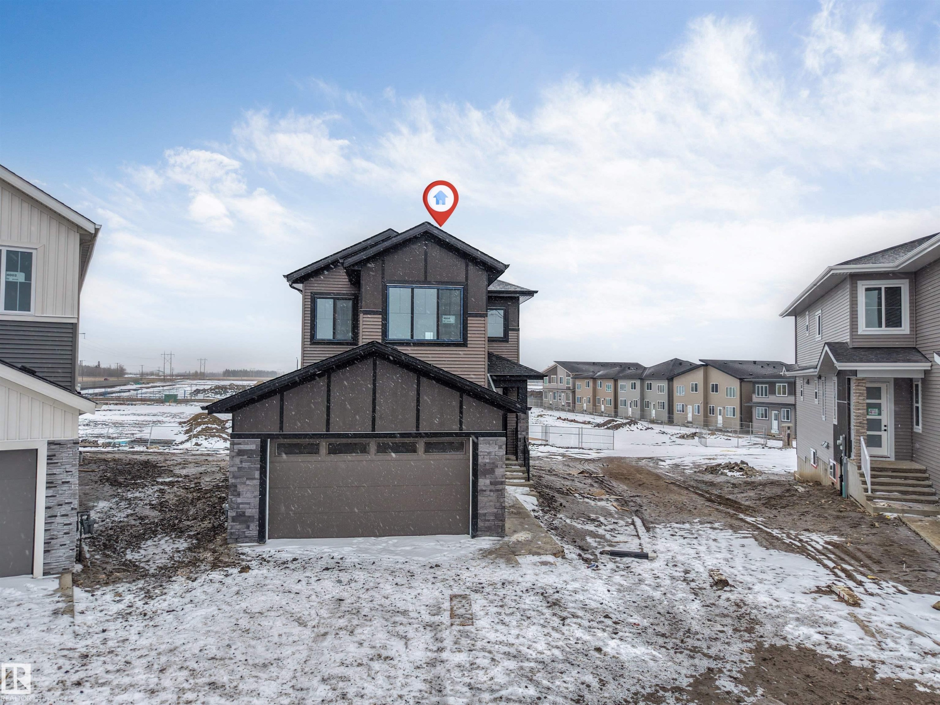 The property features a two-story exterior with a combination of horizontal siding and stone accents - 4004 35 Street, Beaumont, AB - Outdoor