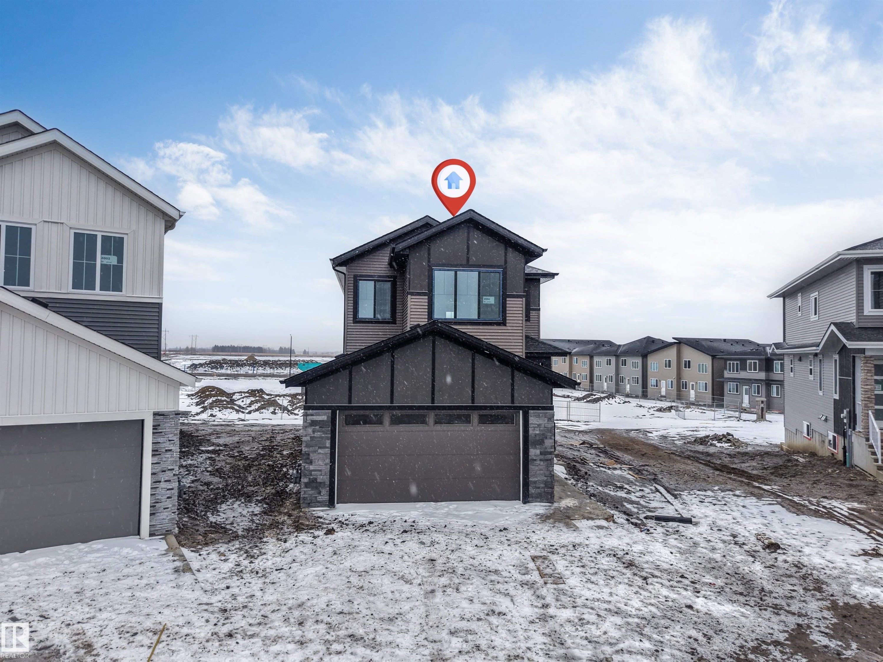 The property features a dark-toned exterior with lighter brown accents and a two-story design - 4004 35 Street, Beaumont, AB - Outdoor