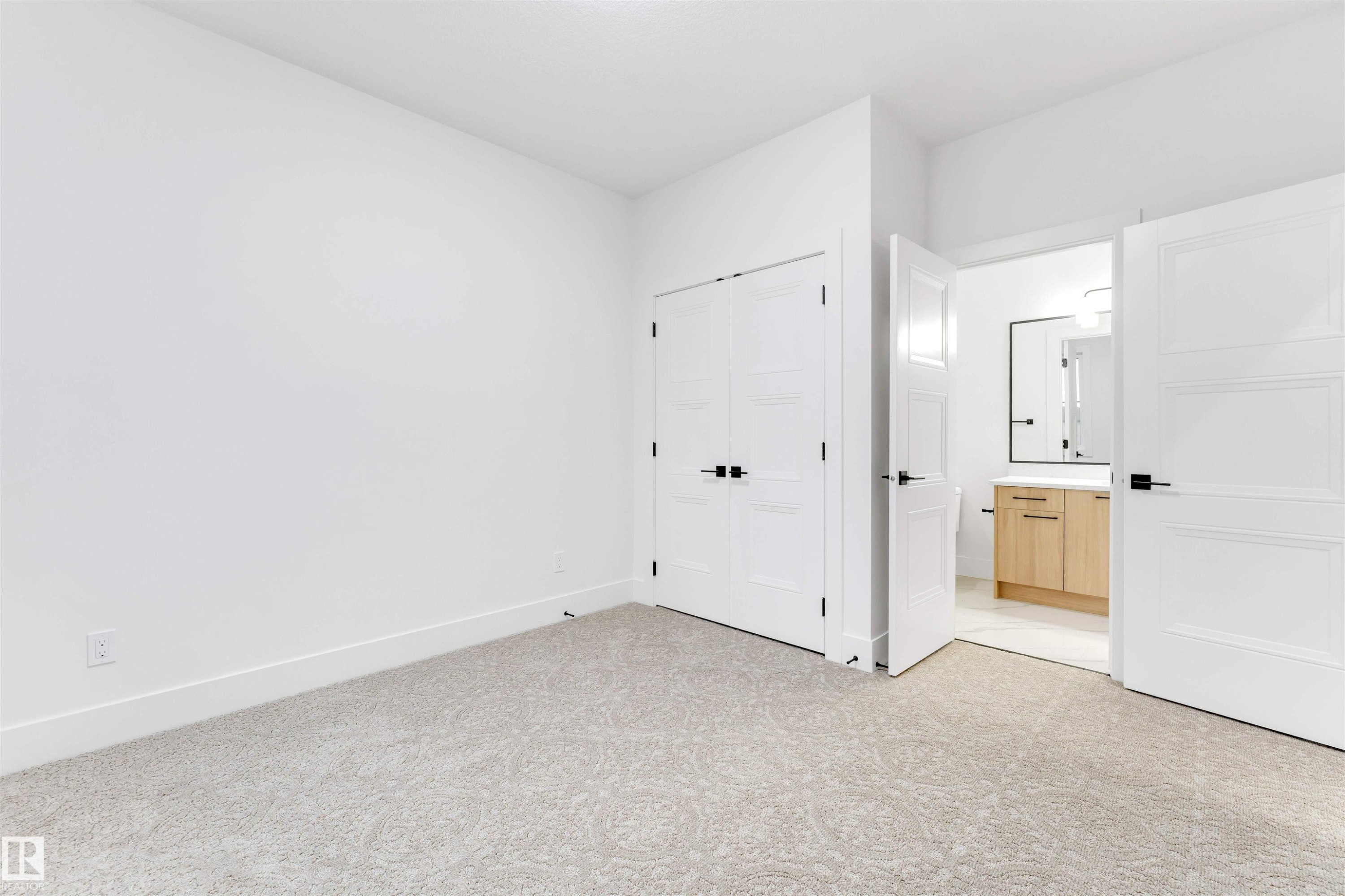 The property features light-colored carpet, white walls, and white trim - 4004 35 Street, Beaumont, AB - Indoor Photo Showing Other Room