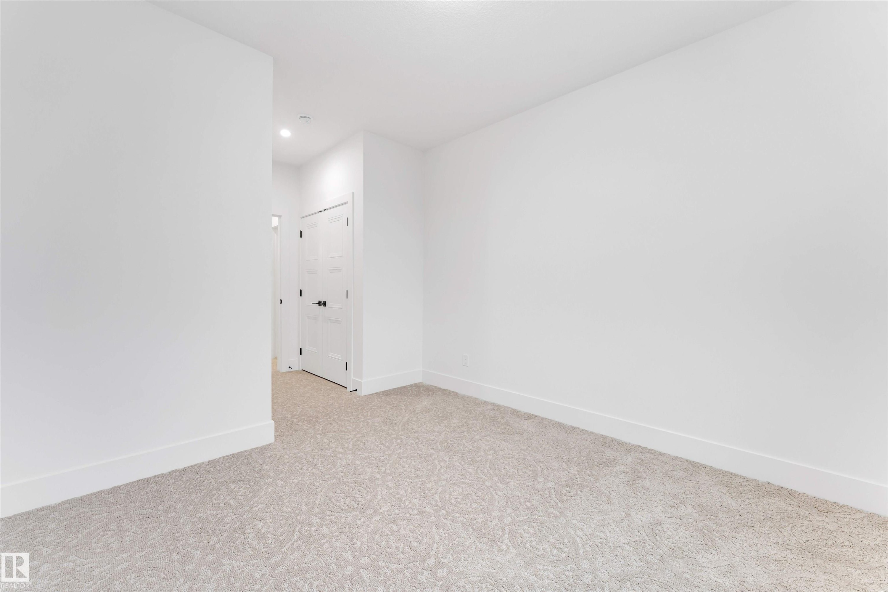 This versatile room features light-colored carpeting, white walls, and recessed lighting, offering a neutral canvas - 4004 35 Street, Beaumont, AB - Indoor Photo Showing Other Room
