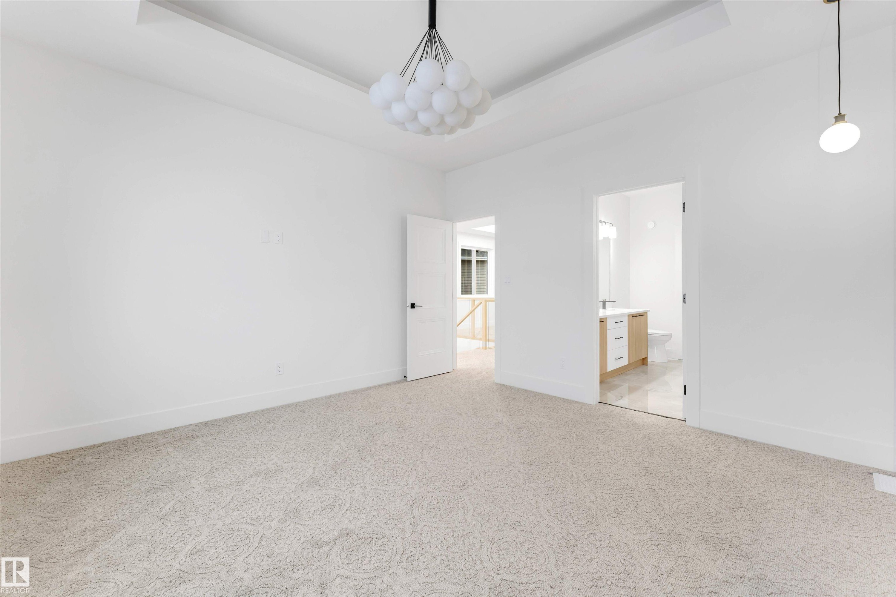 This room features light-colored patterned carpet and white walls - 4004 35 Street, Beaumont, AB - Indoor Photo Showing Other Room