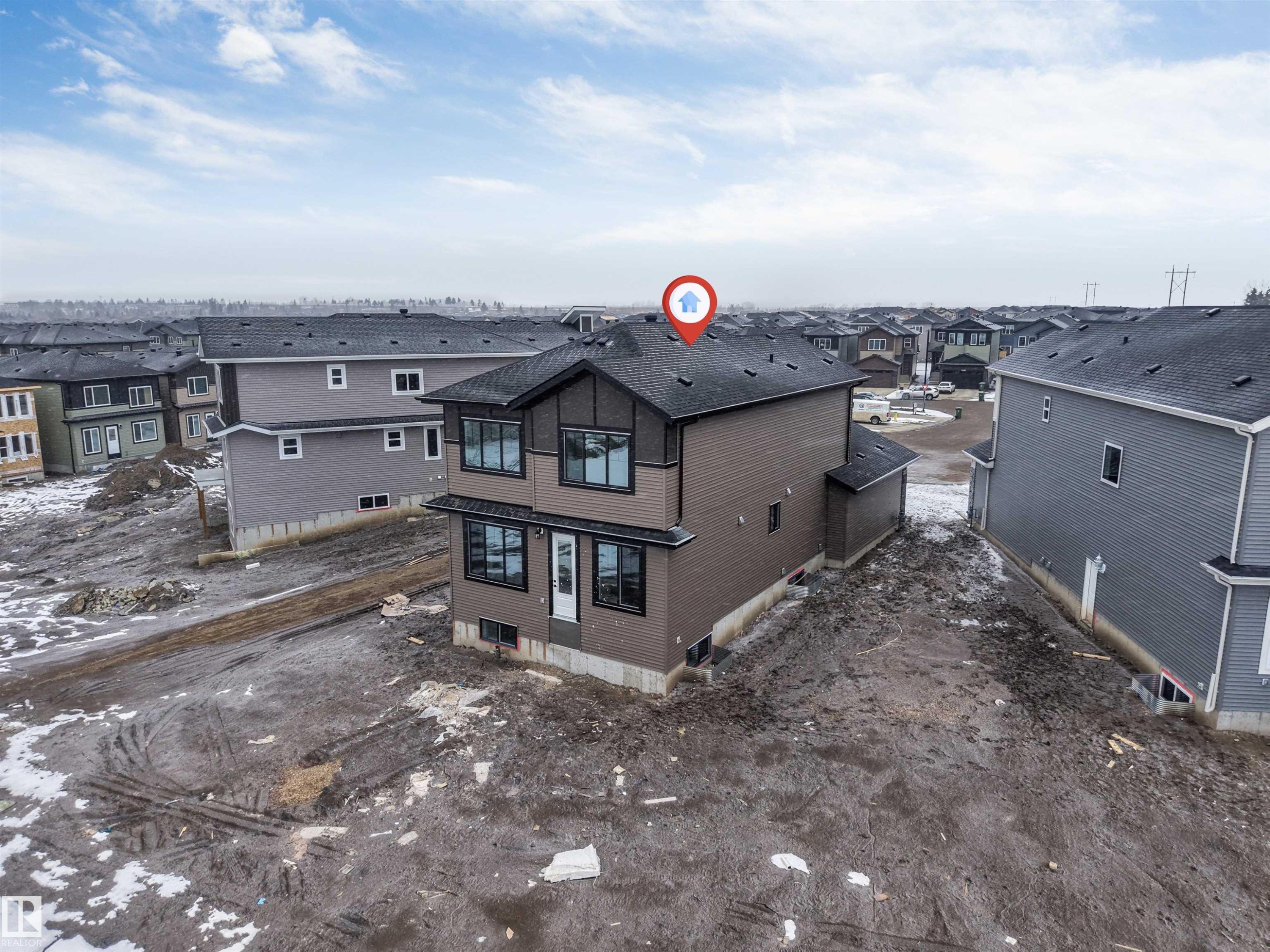 This property features a contemporary exterior with dark siding and contrasting trim - 4004 35 Street, Beaumont, AB - Outdoor
