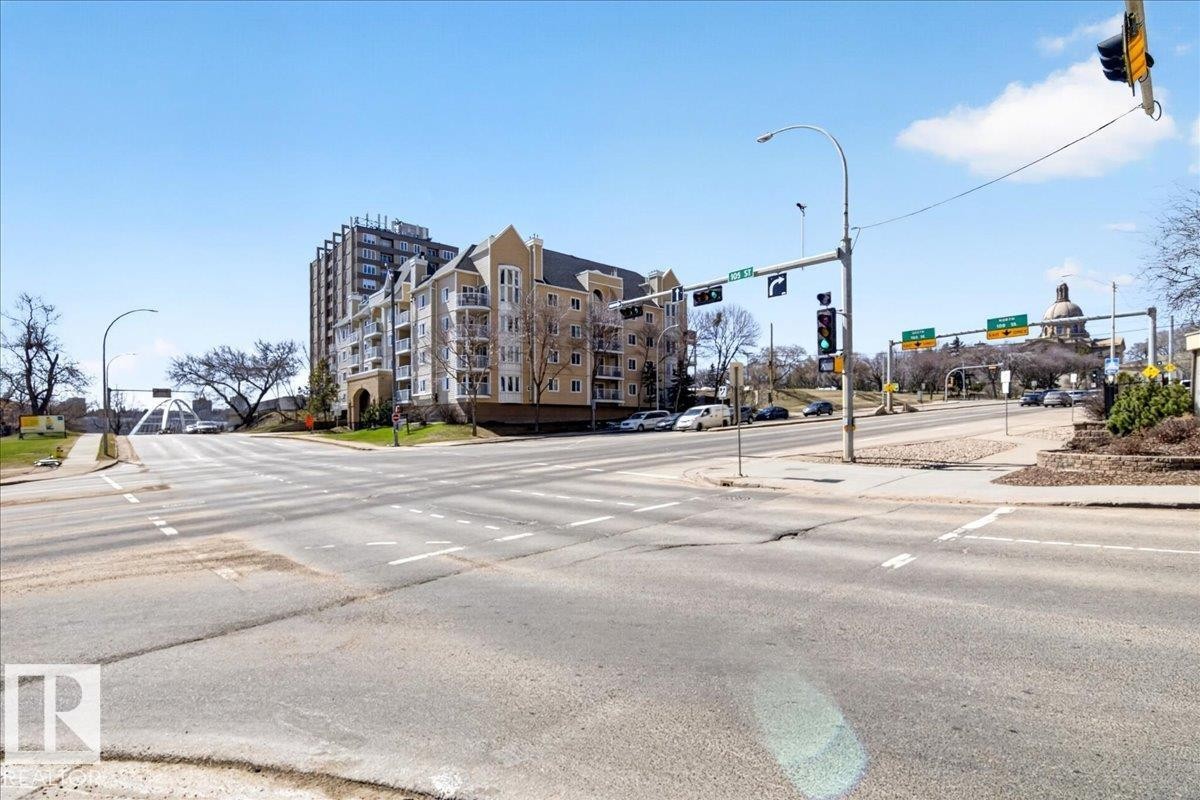 Low-rise building exterior featuring stucco cladding and multiple balconies - 701 9707 105 Street, Edmonton, AB - Outdoor
