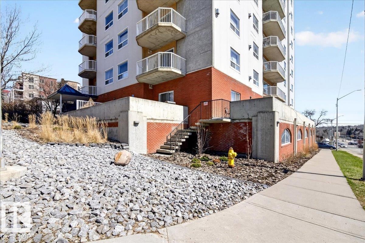 Multi-story building featuring a brick and concrete facade with multiple private balconies - 701 9707 105 Street, Edmonton, AB - Outdoor With Balcony