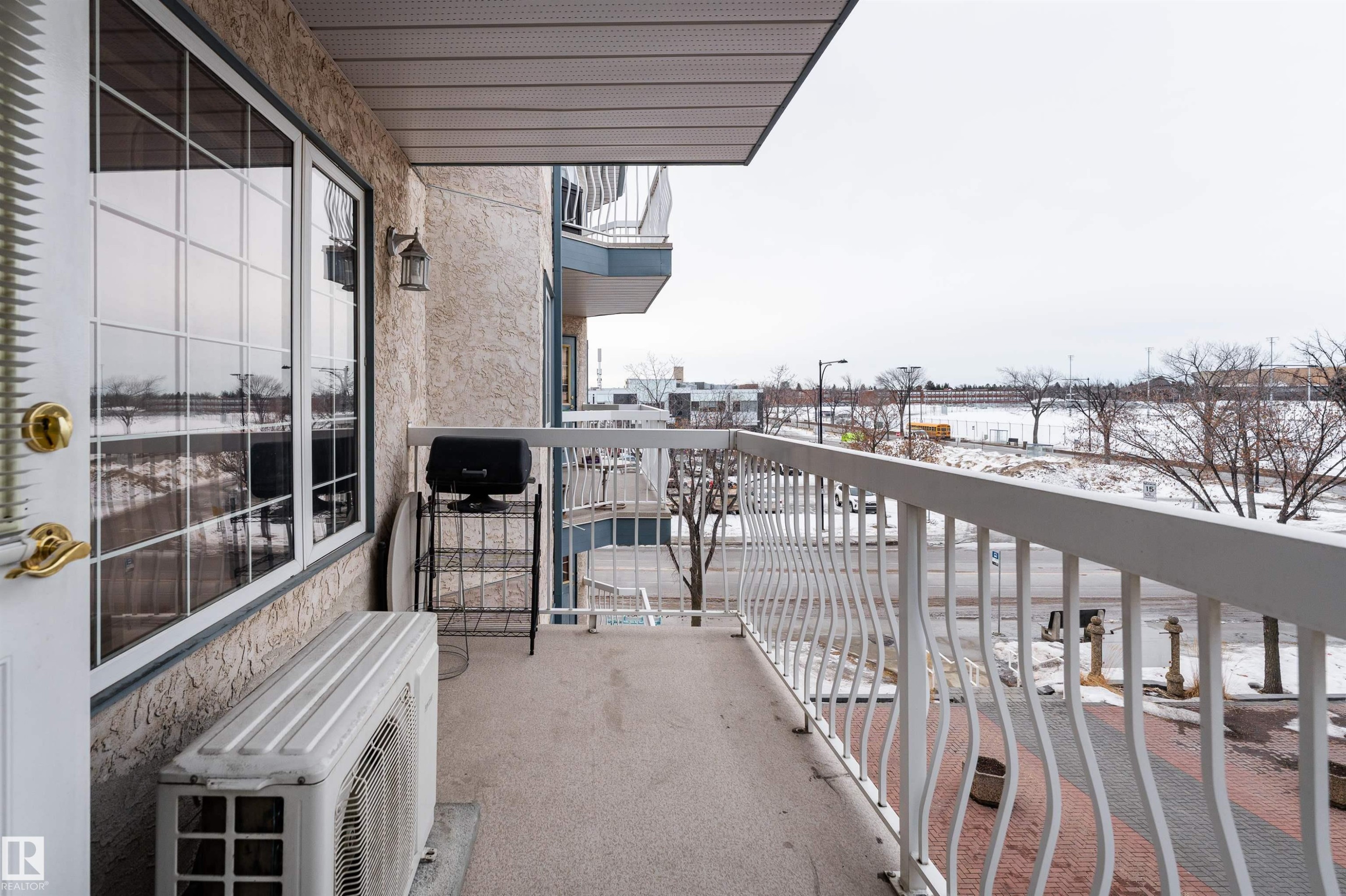 View of snow covered back of property - 309 13540 114 Avenue, Edmonton, AB