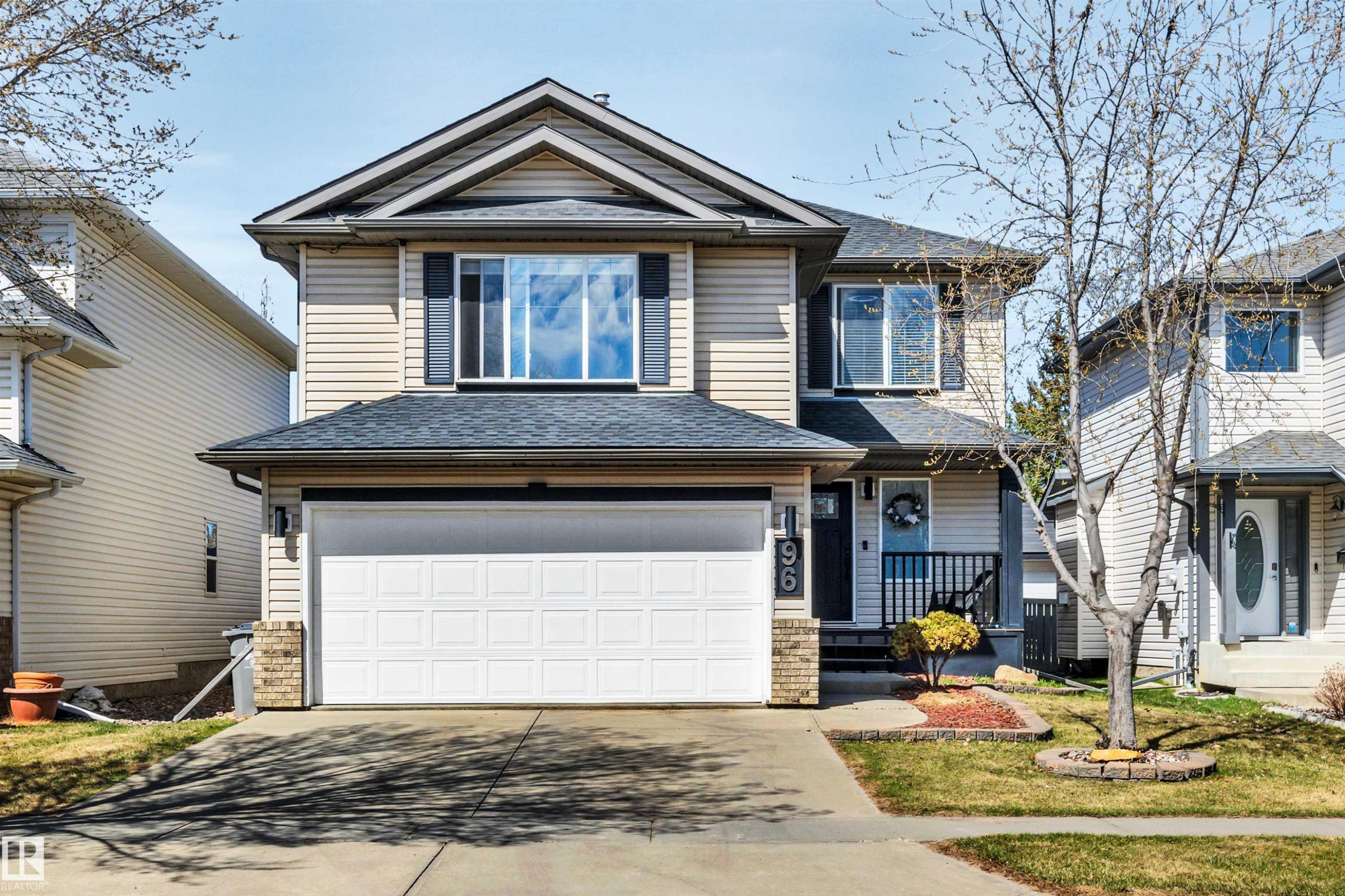 Two-story residence featuring light-colored horizontal siding and a dark shingle roof - 96 Bonin Crescent, Beaumont, AB - Outdoor With Facade