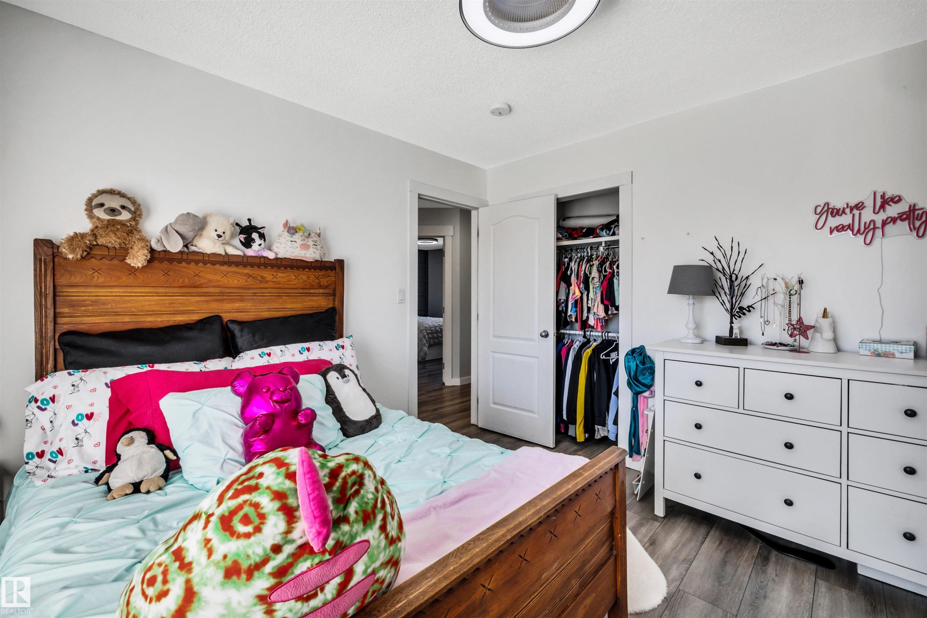 Bedroom featuring wood-finish flooring, white walls, and a built-in closet with double doors - 96 Bonin Crescent, Beaumont, AB - Indoor Photo Showing Bedroom