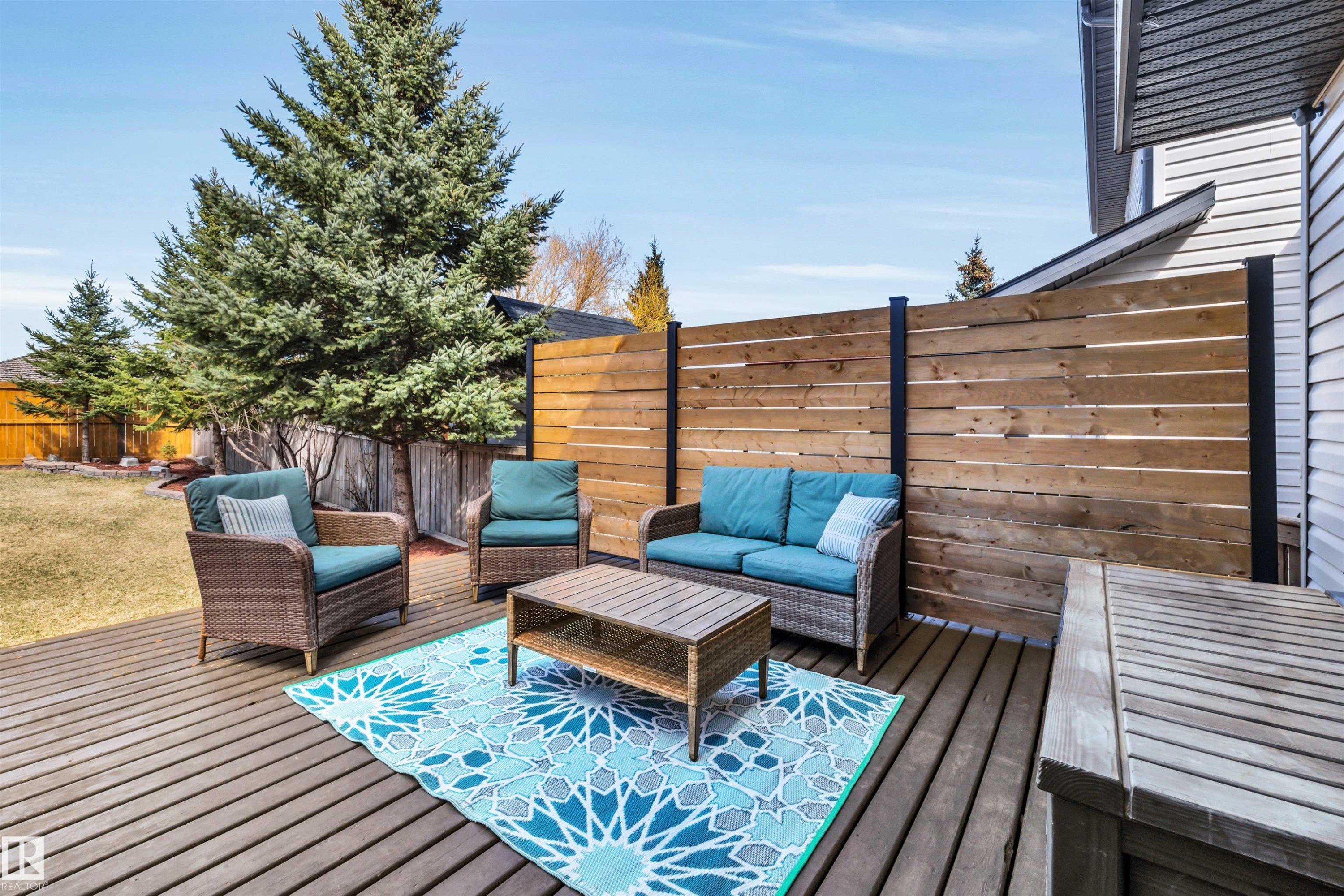 Hardwood deck with a horizontal plank privacy fence and extensive grassy yard - 96 Bonin Crescent, Beaumont, AB - Outdoor With Deck Patio Veranda With Exterior